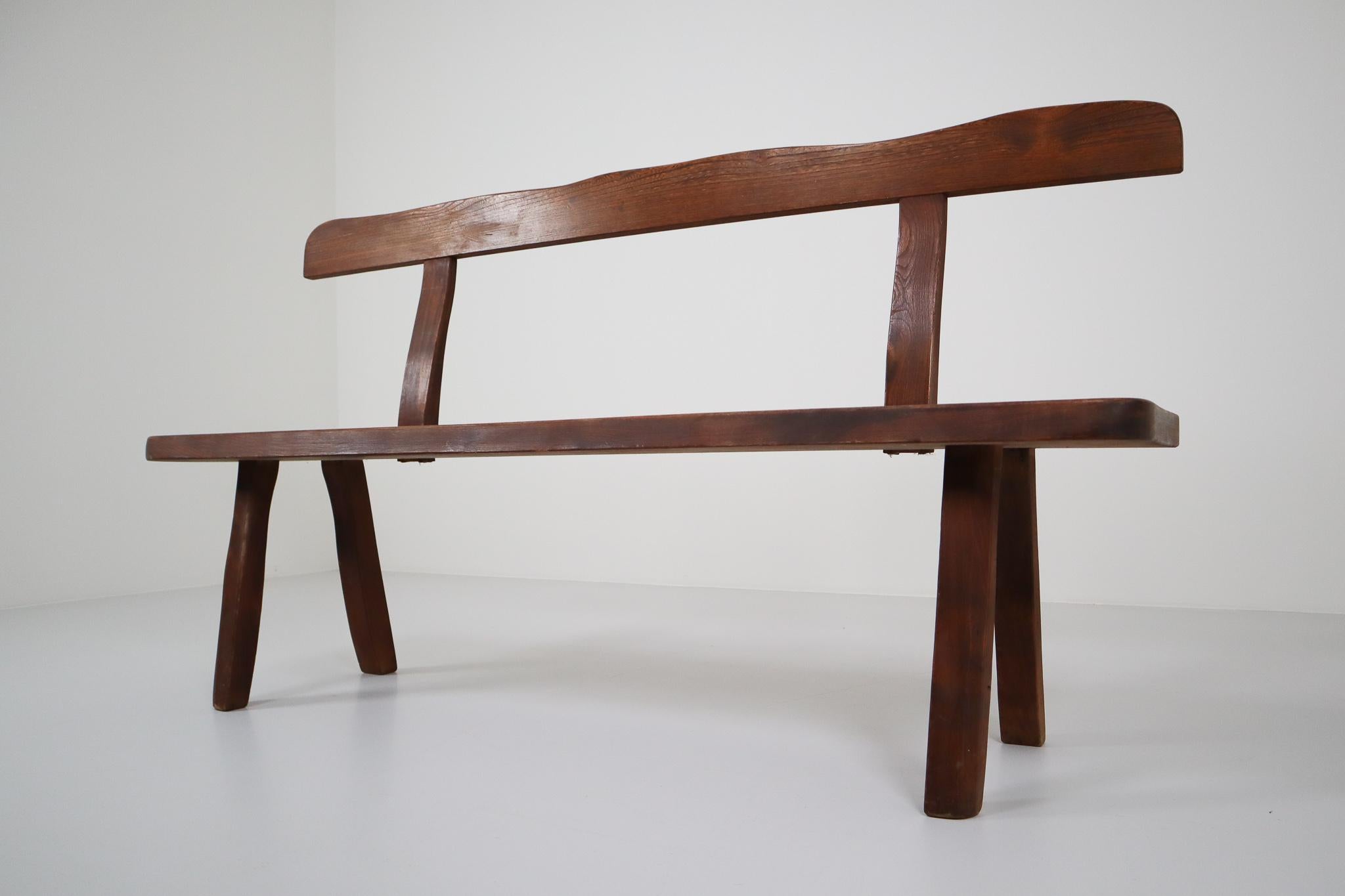 Robust sculptural bench designed by Olavi Hanninen and manufactured by Mikko Nupponen. This bench is made of stained elmwood and sculpturally crafted by hand very minimalistic, yet Brutalistic shaped and in very good original condition. The Finnish