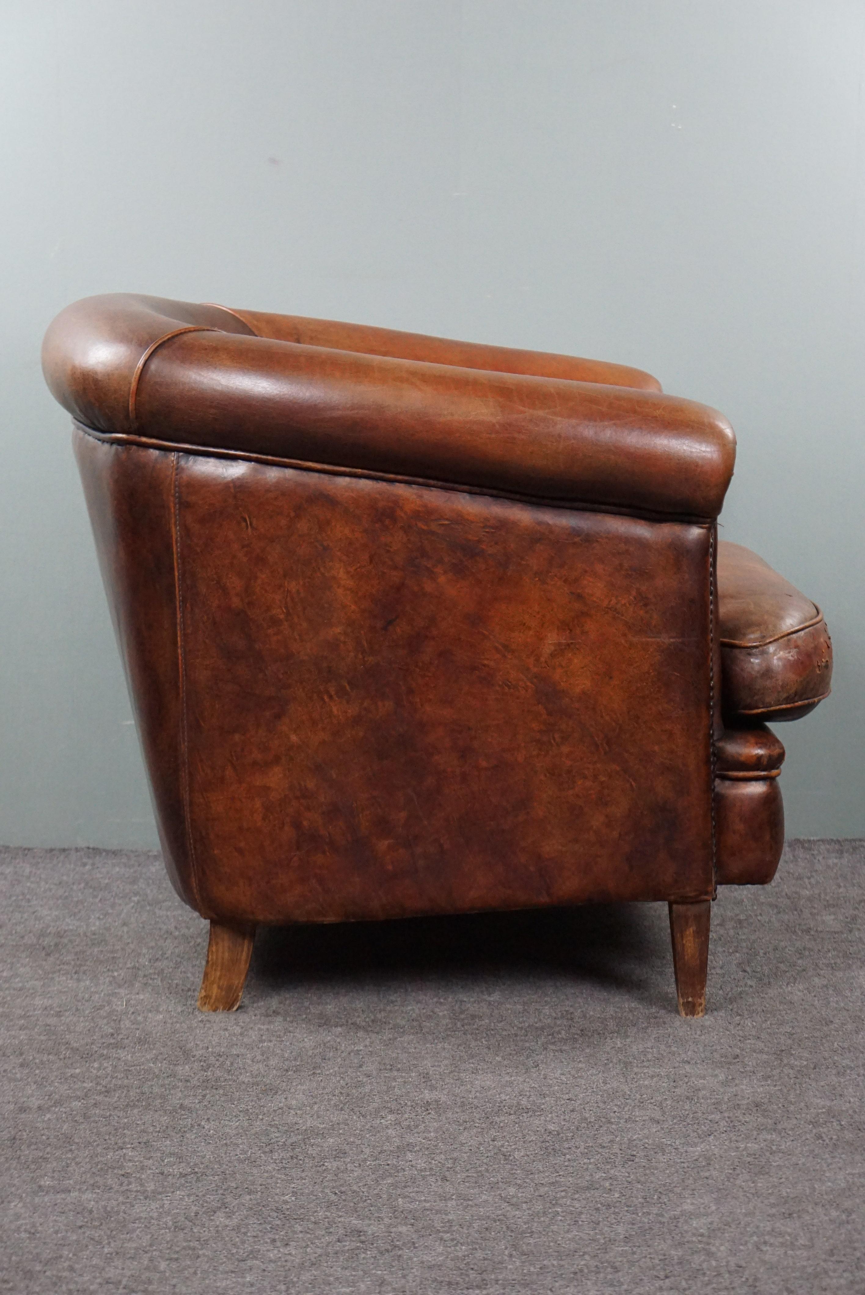 Offered is this handsome, robust sheep leather club armchair in a rich cognac color with a comfortable seat. This sturdy yet comfortable sheep leather armchair will warmly welcome you every day after a hard day's work.

Despite, or perhaps because