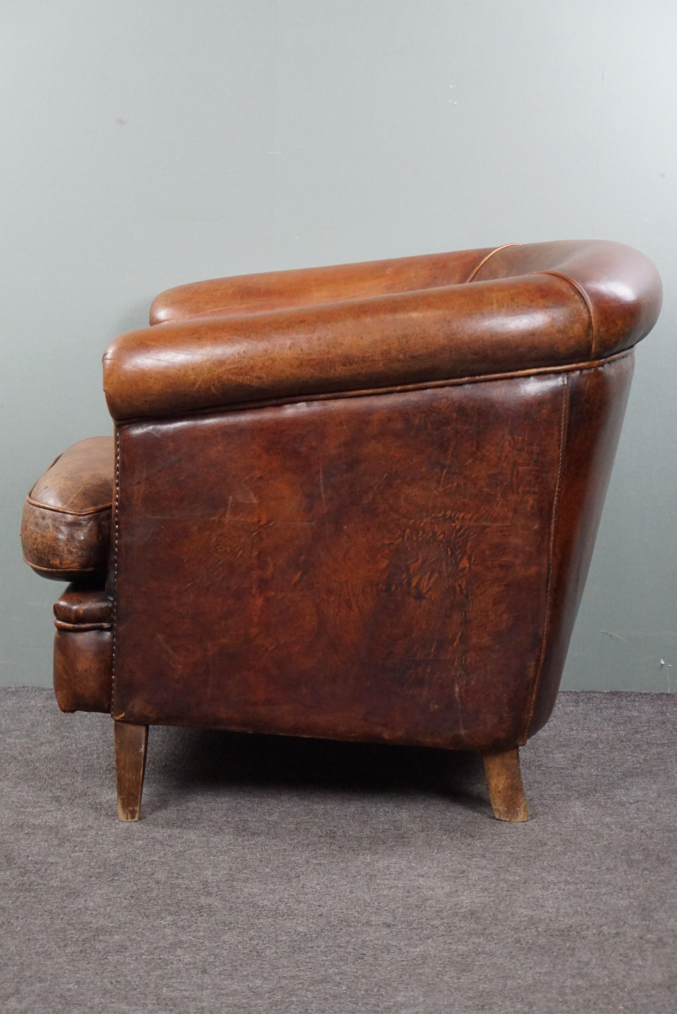 Late 20th Century Robust sheep leather club armchair finished with decorative studs For Sale