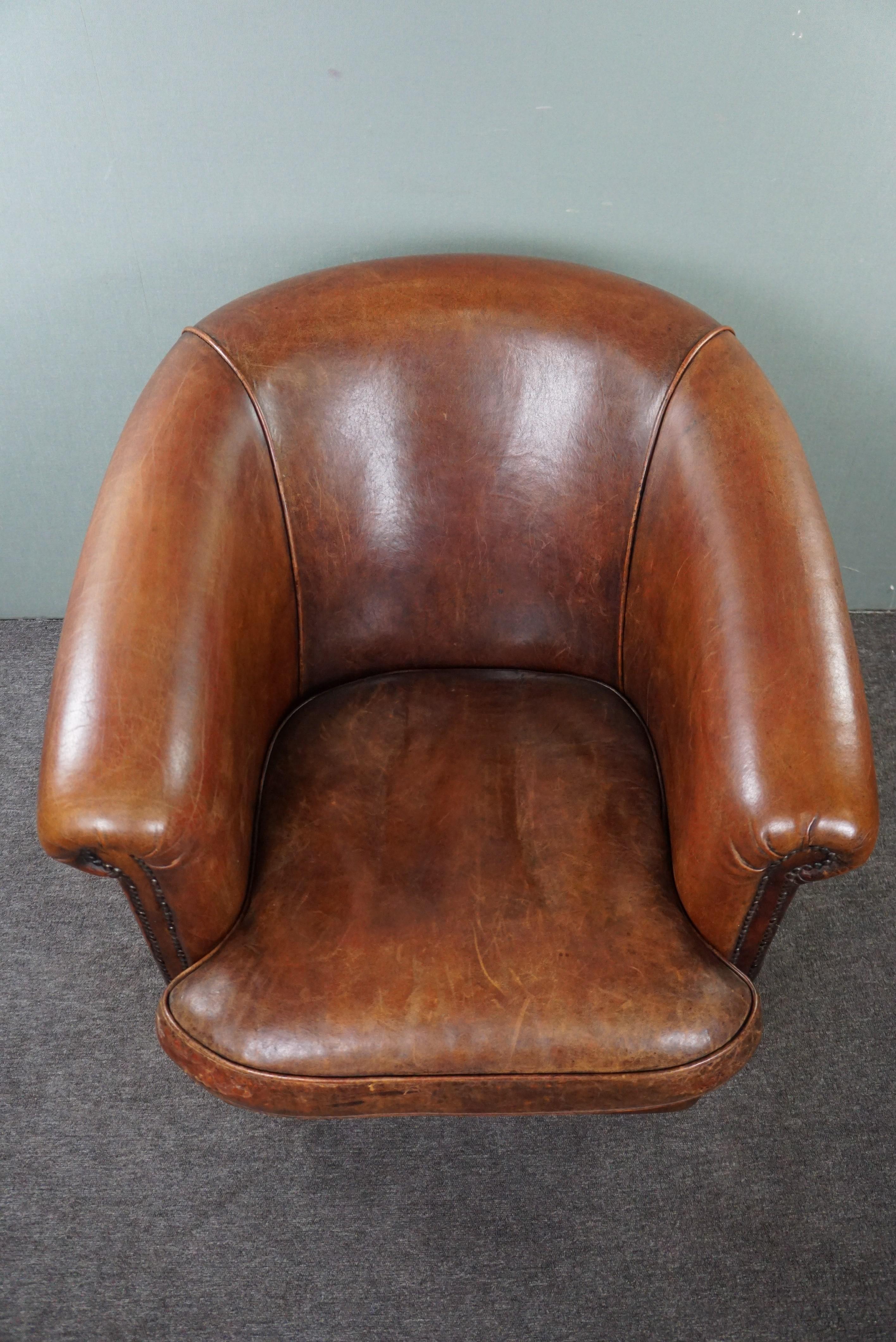 Leather Robust sheep leather club armchair finished with decorative studs For Sale