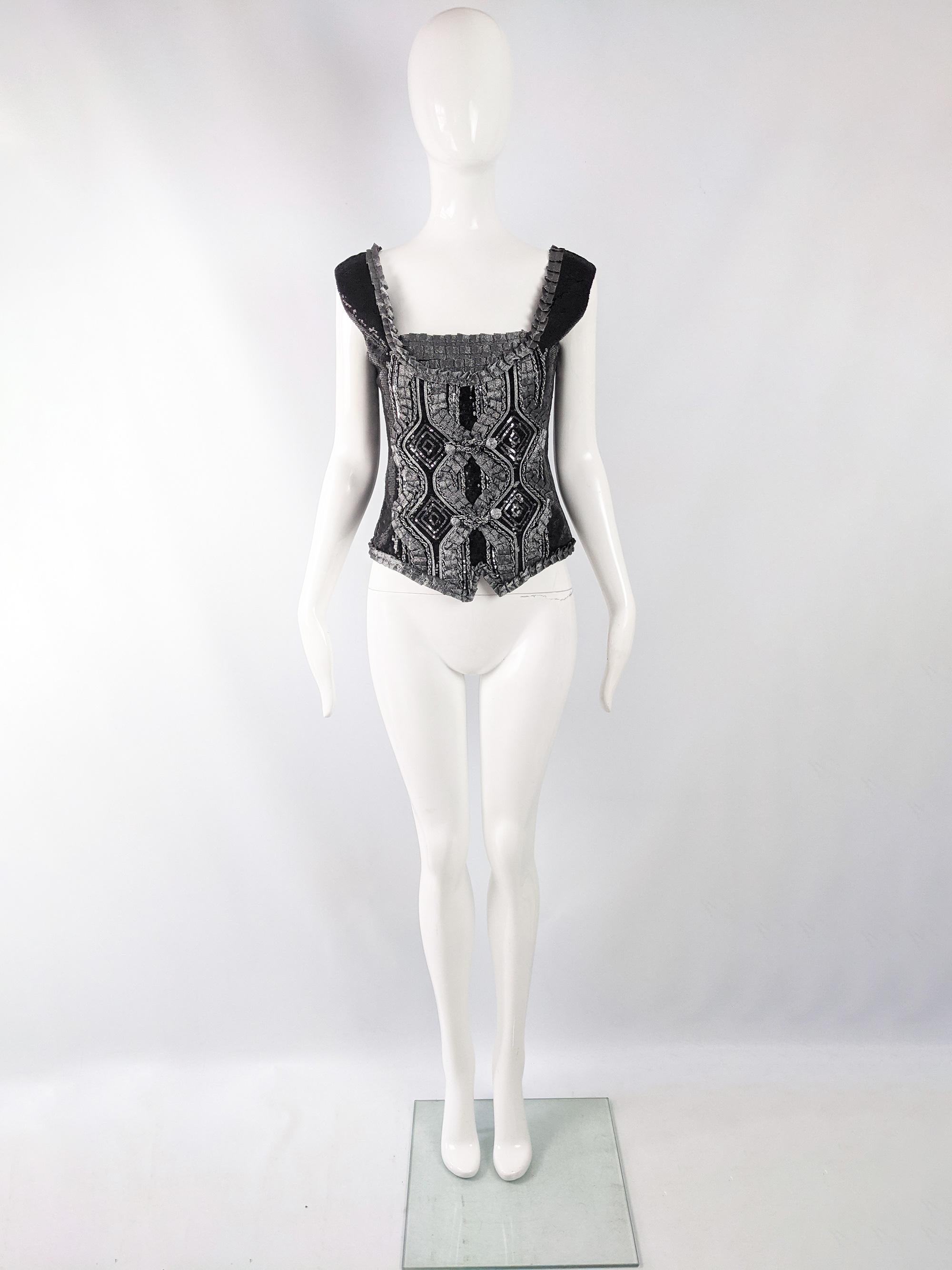 A fabulous vintage Roccobarocco womens sequinned sleeveless top from the early 2000s, perfect for a party. Made in Italy with handmade embroidery and silver ribbon appliqúes. 

Size: Marked vintage IT 48 / 34” but measures more like a modern UK 10/