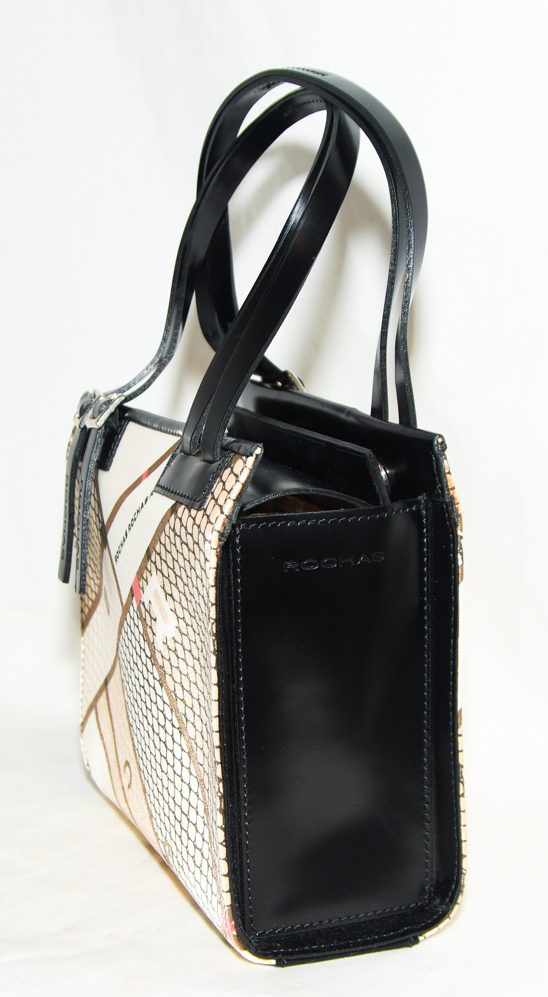 Rochas black leather bag incorporates 2 handles on each side of structured top handle bag with buckles on each strap.  Bag opens at top of bag with 2 snaps for closure.  The interior is lined in beige logo jacquard and includes one side zippered