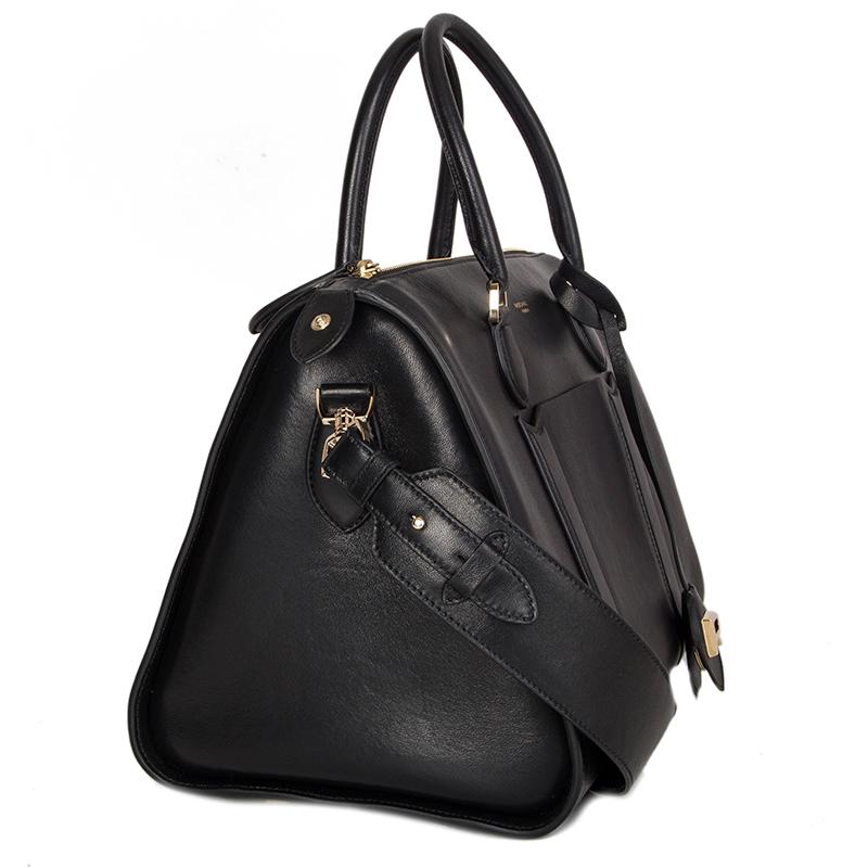 100% authentic Rochas tote bag in black lambskin features a slip pocket against the front and one against the back. Comes with a detachable and adjustable shoulder strap and opens with a zipper on top. Lined in off-white leather and an internal slip