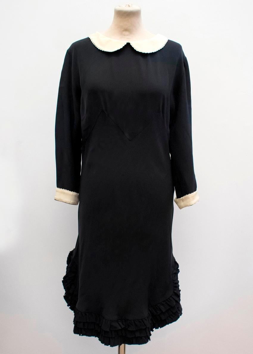 Rochas black silk dress. 

Features contrasting cream cuffs and peter pan collar with frilly layered hem. Made in Italy.

100% Silk

Approx. 

Bust: 54 cm
Waist: 42 cm
Length: 93 cm
Sleeve length: 46.5 cm