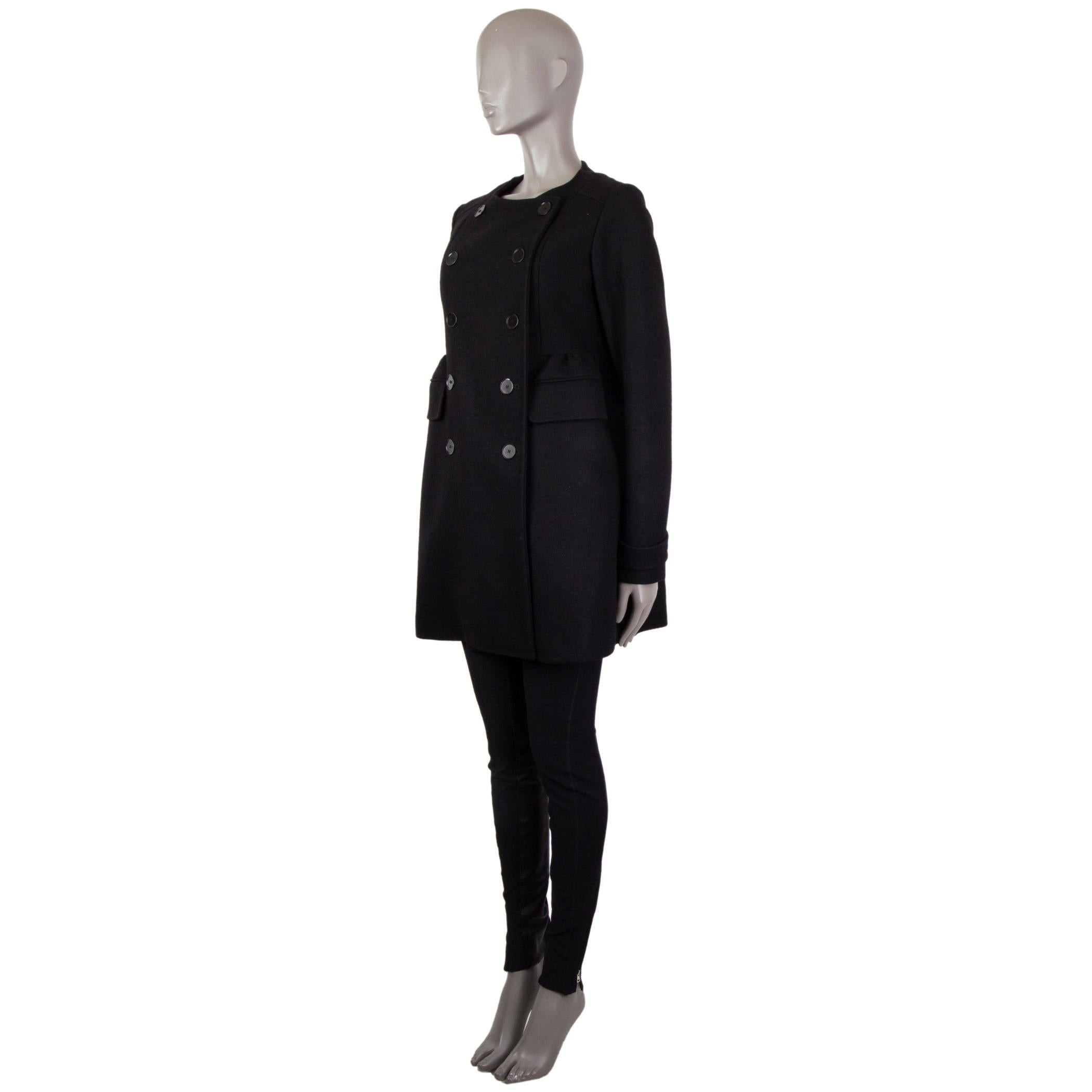 100% authentic Rochas collarless peacoat in black virgin wool (75%), nylon (15%), and cashmere (10%). With bell-shaped gathered waist, pleated back, two flap pockets on the sides, and buttoned cuff straps. Closes with black buttons on the front.