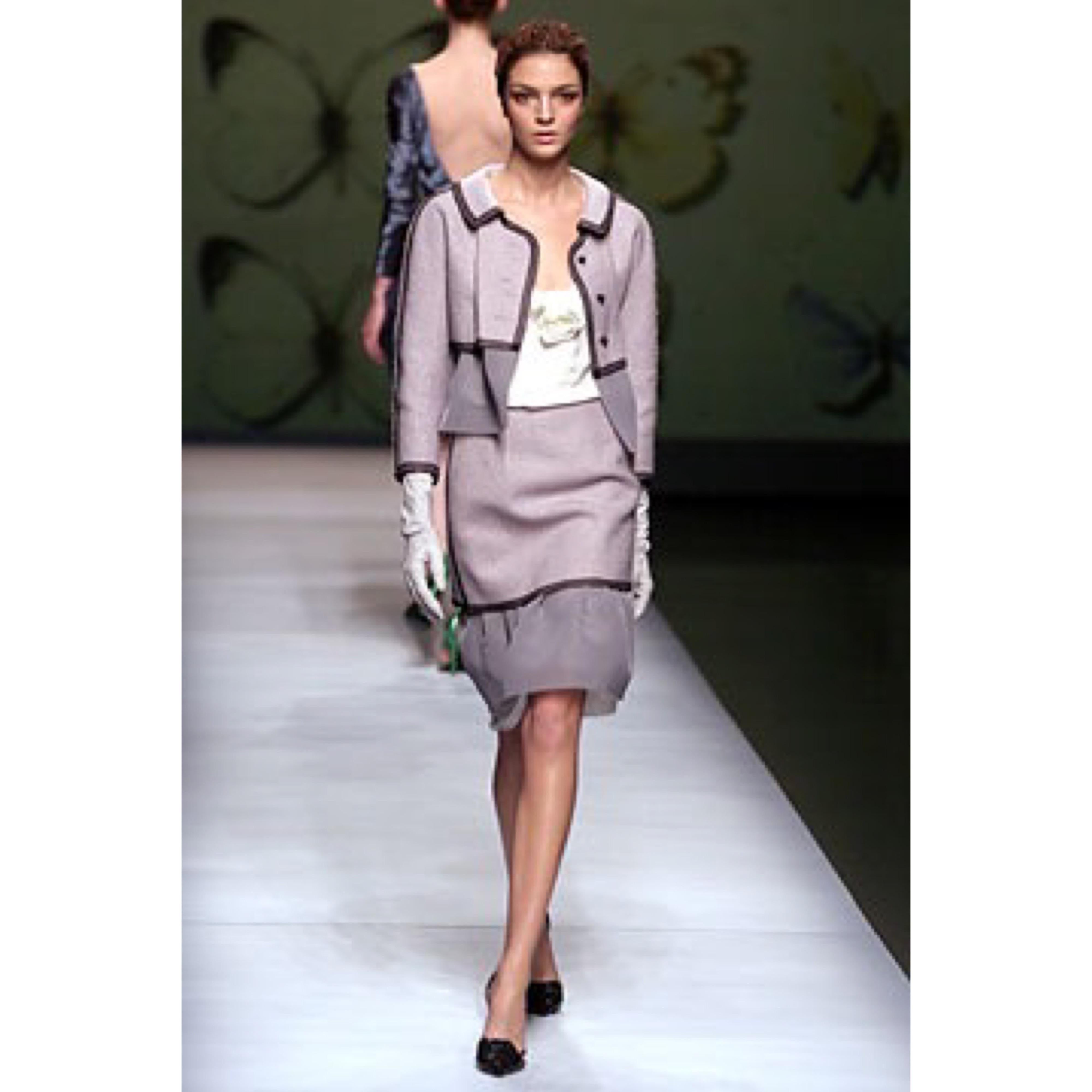 Beautiful vintage Olivier Theyskens for Rochas Runway Fall 2004 light purple, black and gray skirt suit ! Pillbox jacket features three black enamel buttons up the front. Semi sheer mesh detail at waist. High waisted skirt has hidden zipper up the
