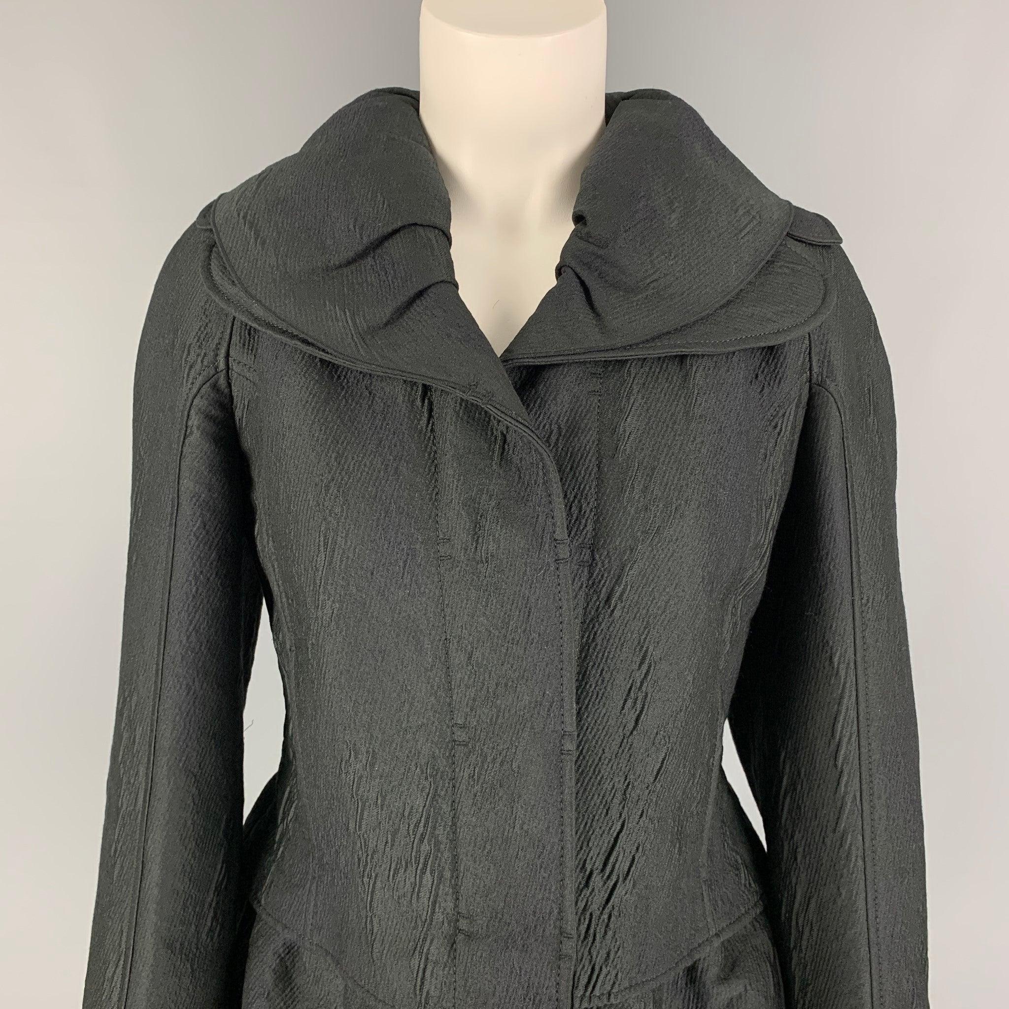 ROCHAS jacket comes in a black textured wool featuring a double collar, peplum style, slit pockets, and a hidden placket closure. Made in France.
Very Good
Pre-Owned Condition. 

Marked:   40 

Measurements: 
 
Shoulder: 17 inches  Bust: 36 inches 