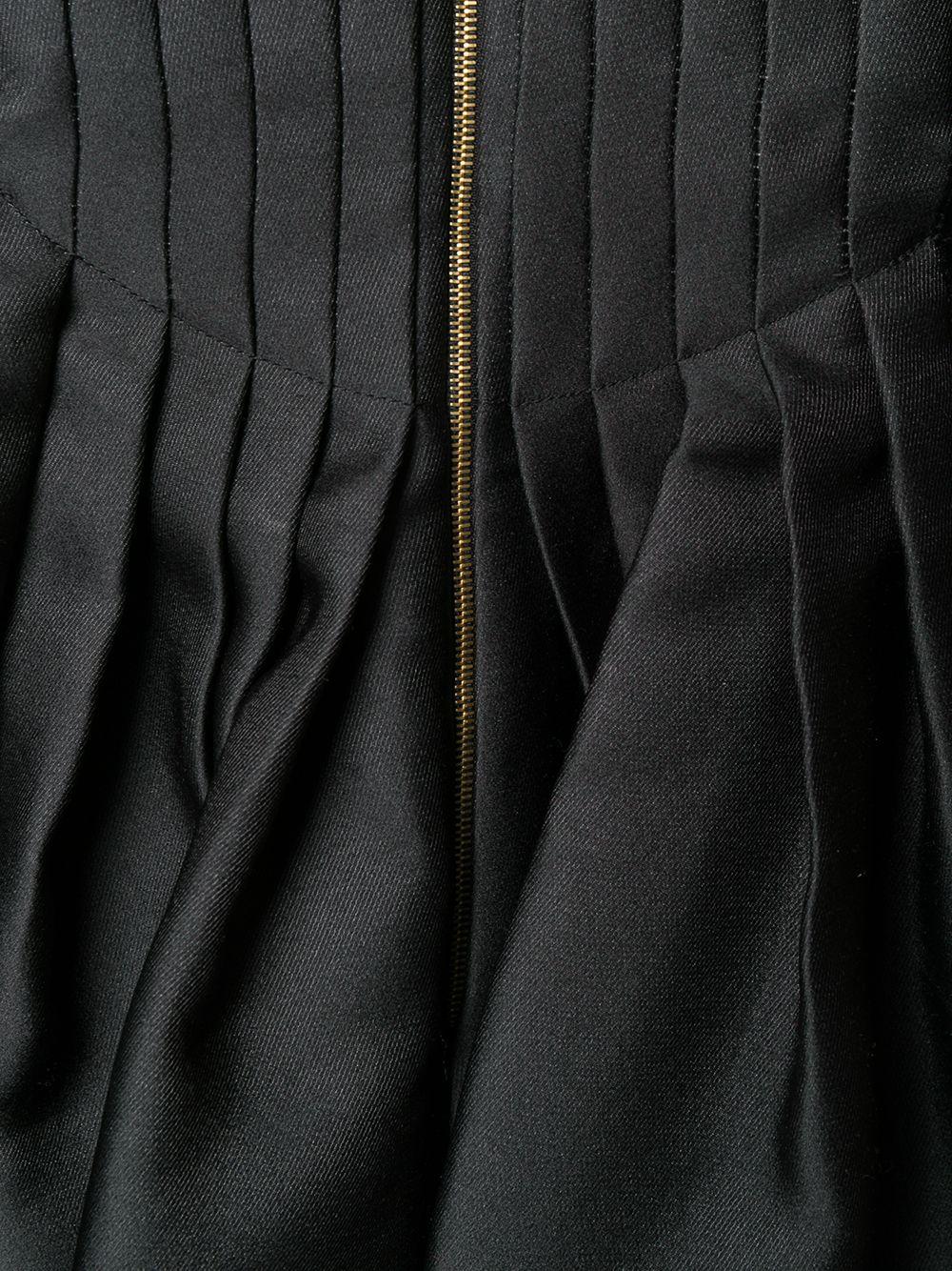 Crafted in Italy from an intricate combination of velvet and rayon, this pre-owned, couture gown by Rochas is expertly cut on the bias to reveal a fluid yet fitted silhouette. Showcasing a distinctive black velvet front panelled design, the gown