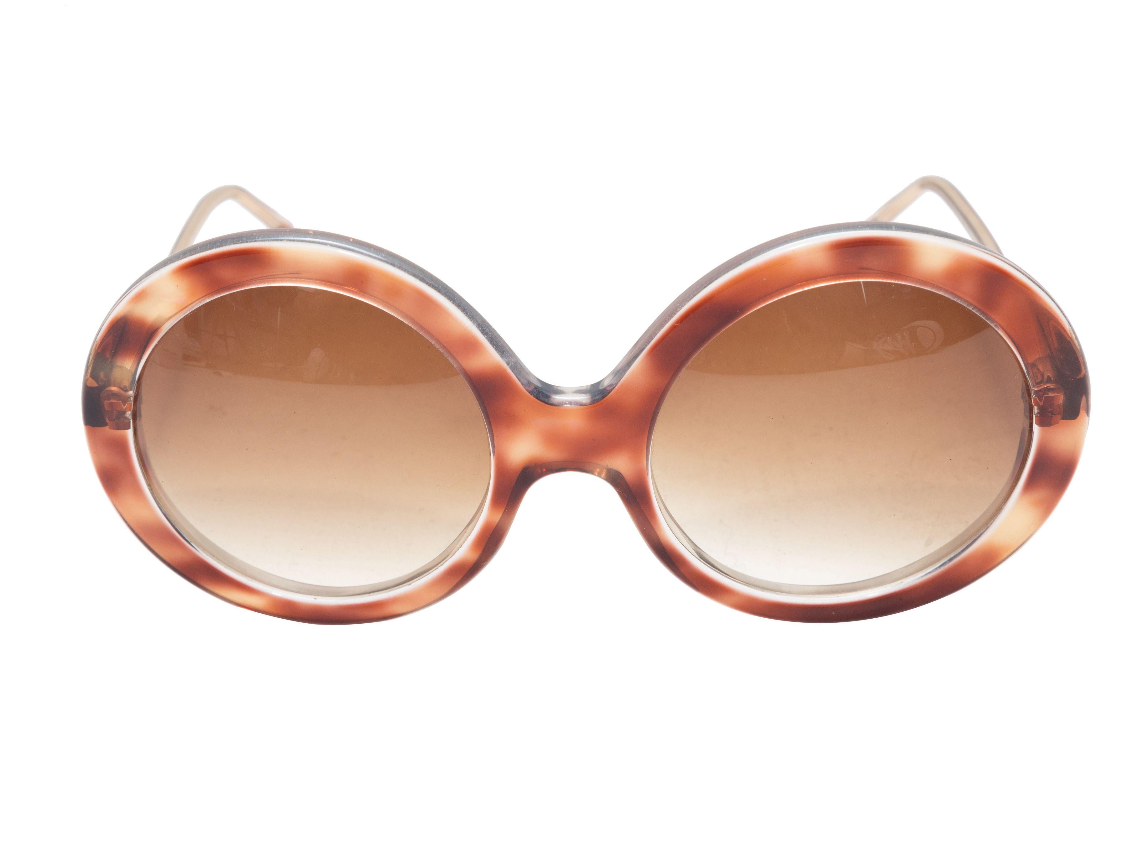 Product Details: Tortoiseshell acetate oversized round sunglasses by Rochas. Brown tinted lenses. 3