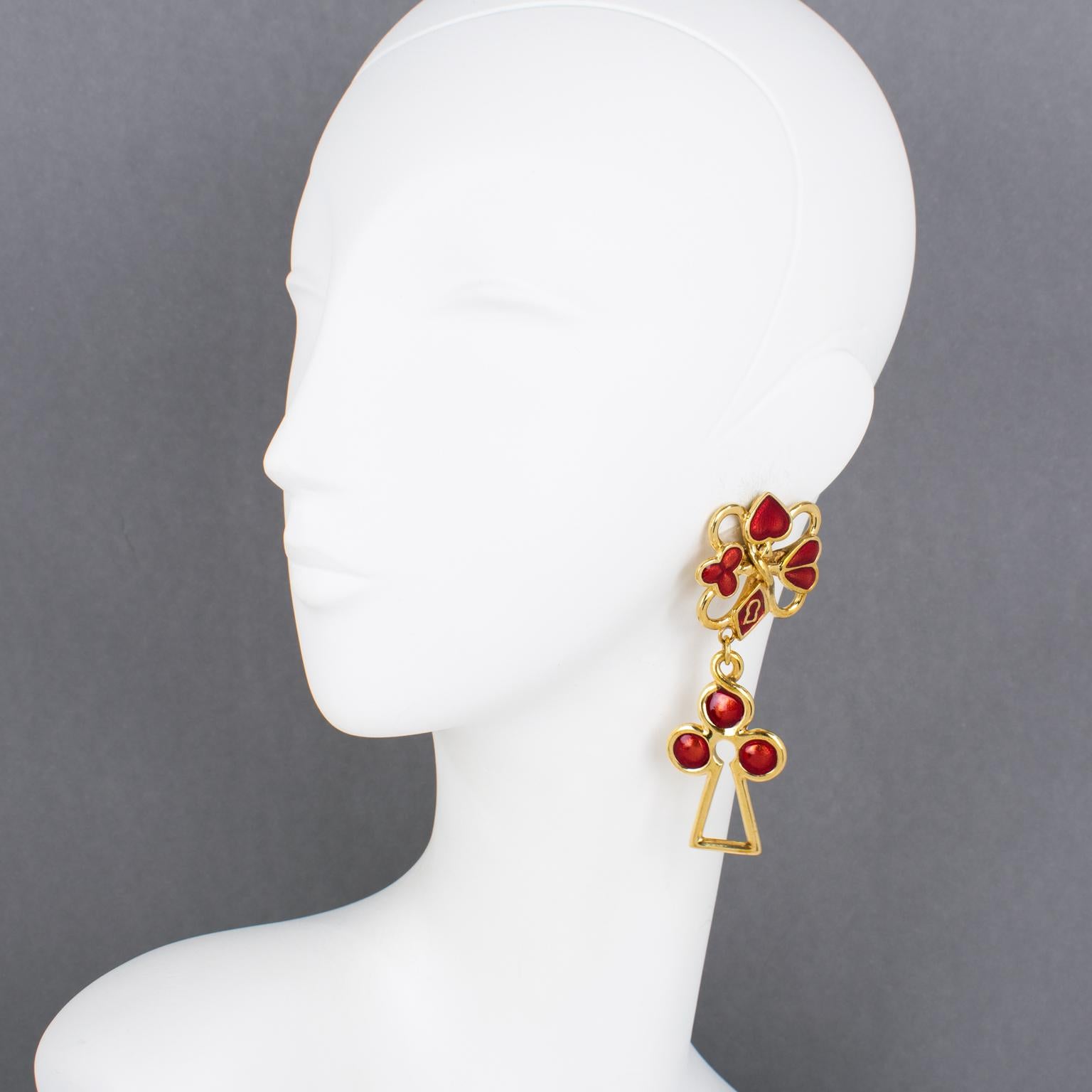 Rochas Paris designed those fabulous dangle clip-on earrings. The rare pieces feature an extra-long dangling drop shape with a gilded metal framing embellished with red enamel. The design is based on the play card symbols: spade, diamond, club, and