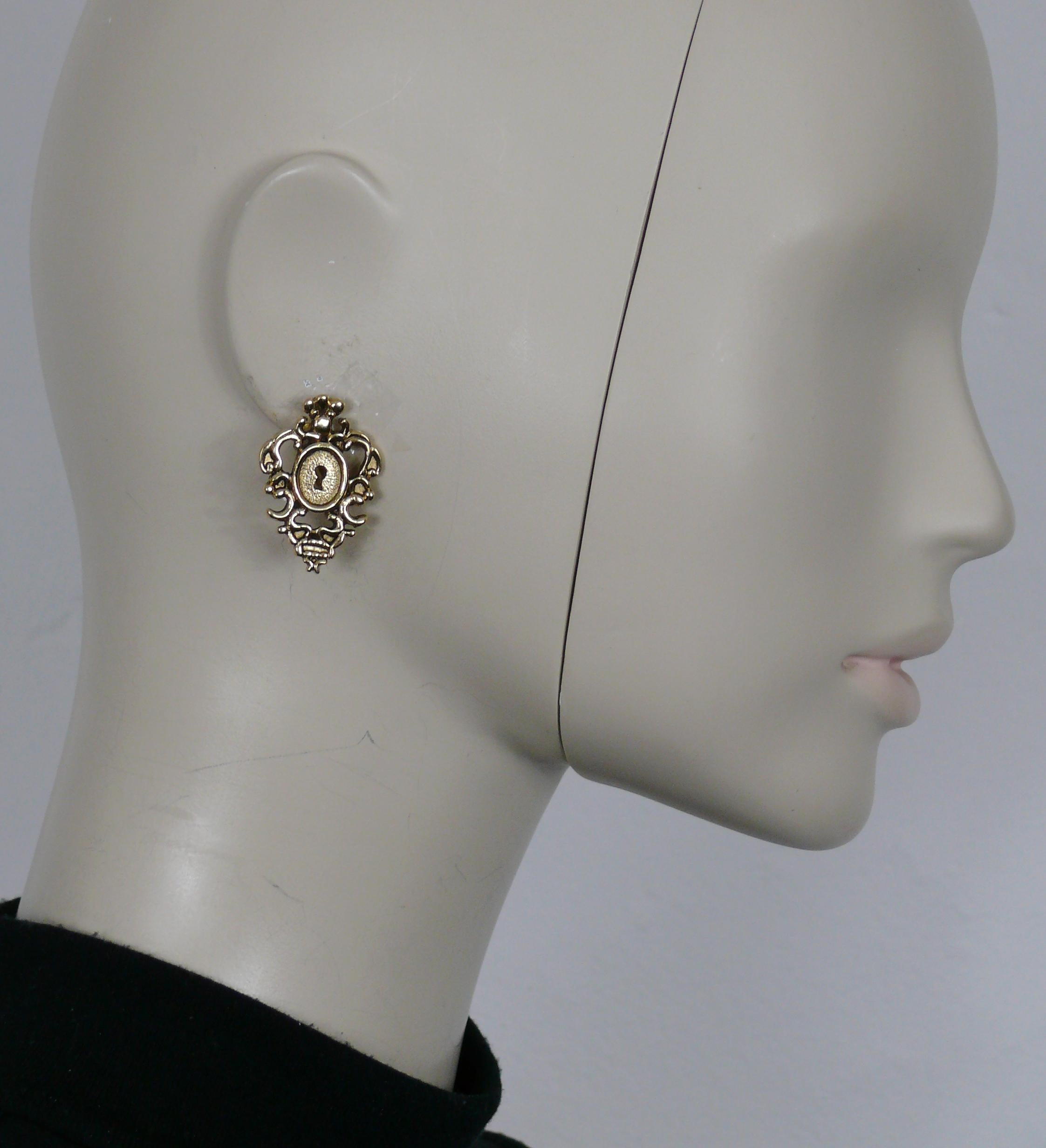 ROCHAS Vintage goldfarbene barocke Ohrringe mit Schlüssellochverschluss.

Geprägte ROCHAS

Ungefähre Maße: max. Höhe ca. 3,4 cm (1,34 Zoll) / max. Breite ca. 2,4 cm (0,94 Zoll).

Gewicht pro Ohrring: ca. 6 Gramm.

MATERIALIEN : Goldfarbene