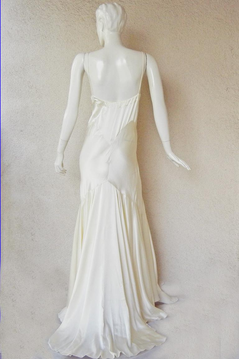As seen on the runway Jean Harlow 1930's inspired gown designed by Rochas.   Fashioned of eggshell white silk charmeuse with plunging neckline; spaghetti straps; chemise style bodice; open back;  extending into a full graceful bias drape skirt. 