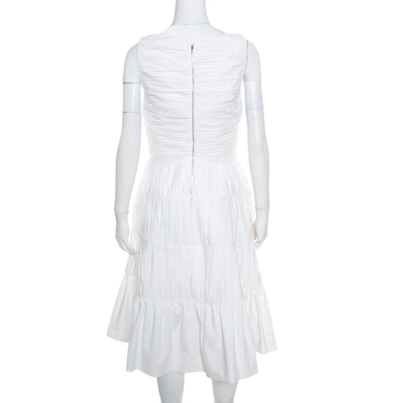 Offering both tactile and visual appeal, this beautiful white dress from Rochas will make you look no less than a diva. The delicate, ruched bodice of the outfit is complemented with a banded waistline and a paneled A-line skirt to create a feminine