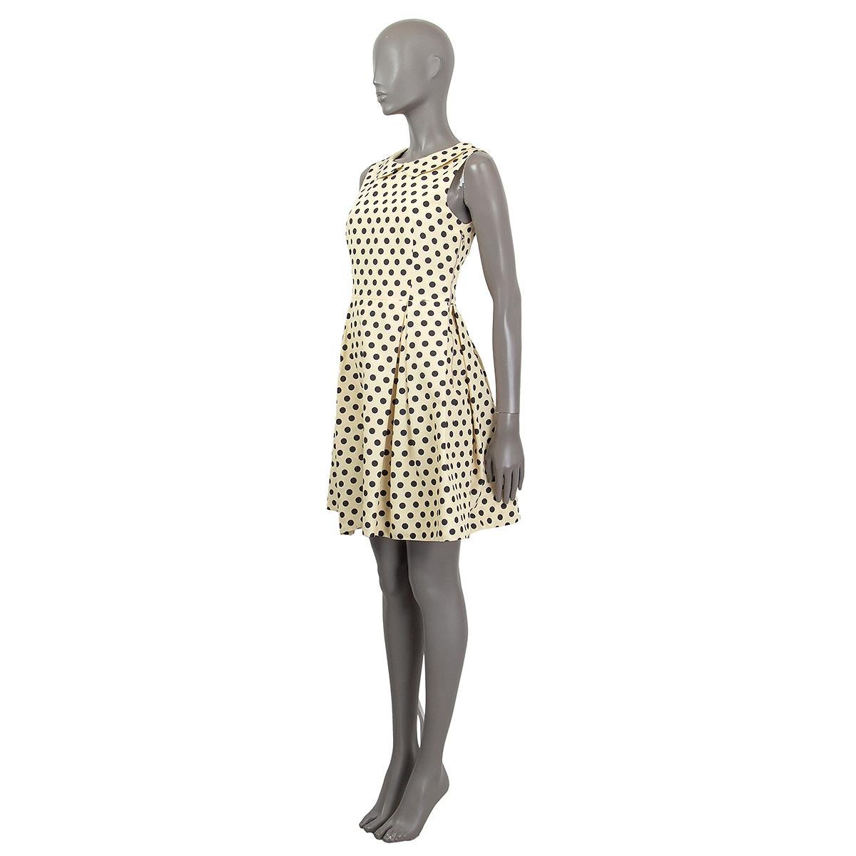 100% authentic Rochas sleeveless polka-dot dress in soft yellow grosgrain cotton (52%) and rayon (48%) with print in black and white. Has a peterpan collar and pleated skirt. Opens with a zipper on the side. Has been worn and is in excellent