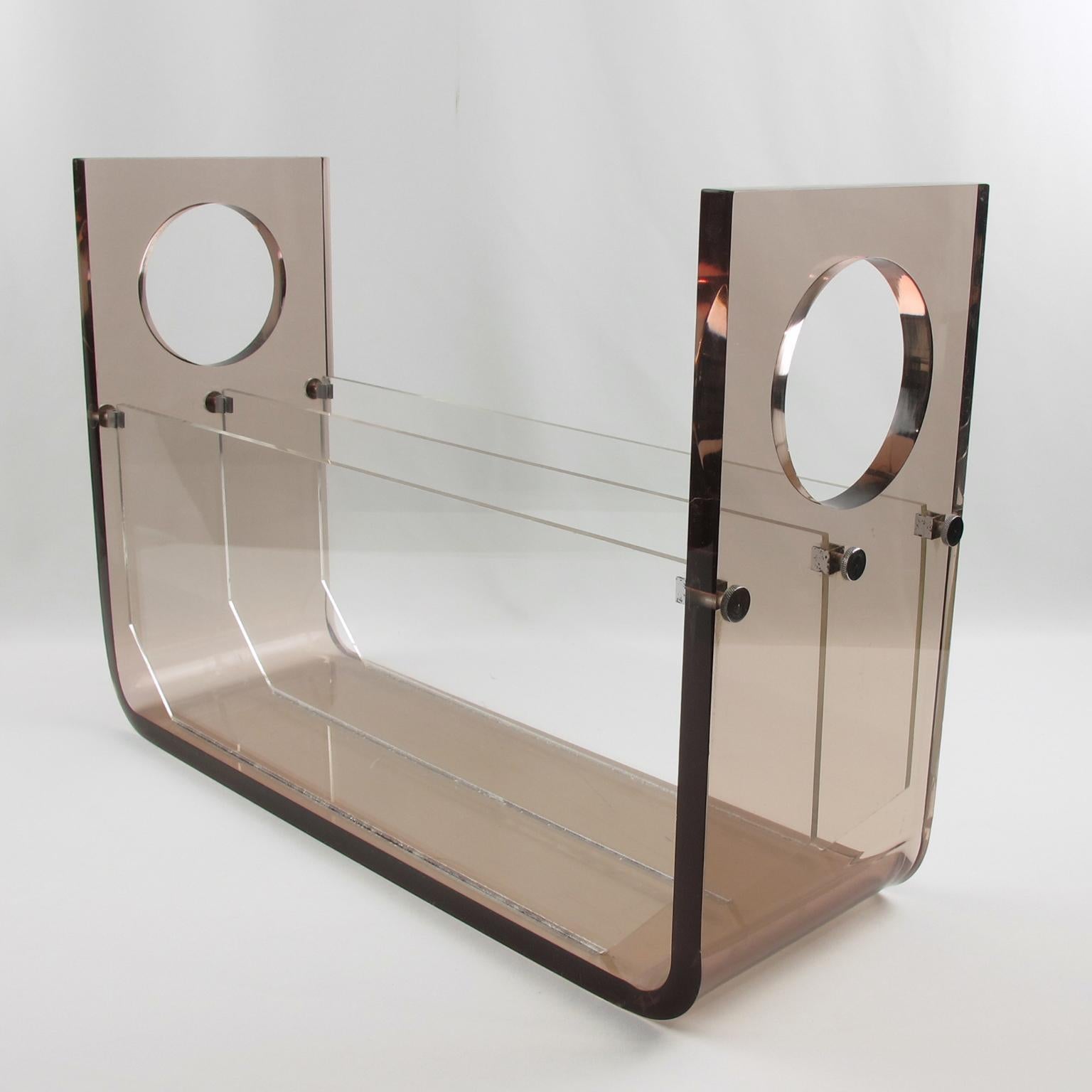 Stunning Lucite or acrylic magazine rack, stand, or holder designed for Roche Bobois, France. This high-quality thick plexiglass construction is reminiscent of work by designer Michel Ducaroy or Michel Dumas. Extra thick smoke gray transparent