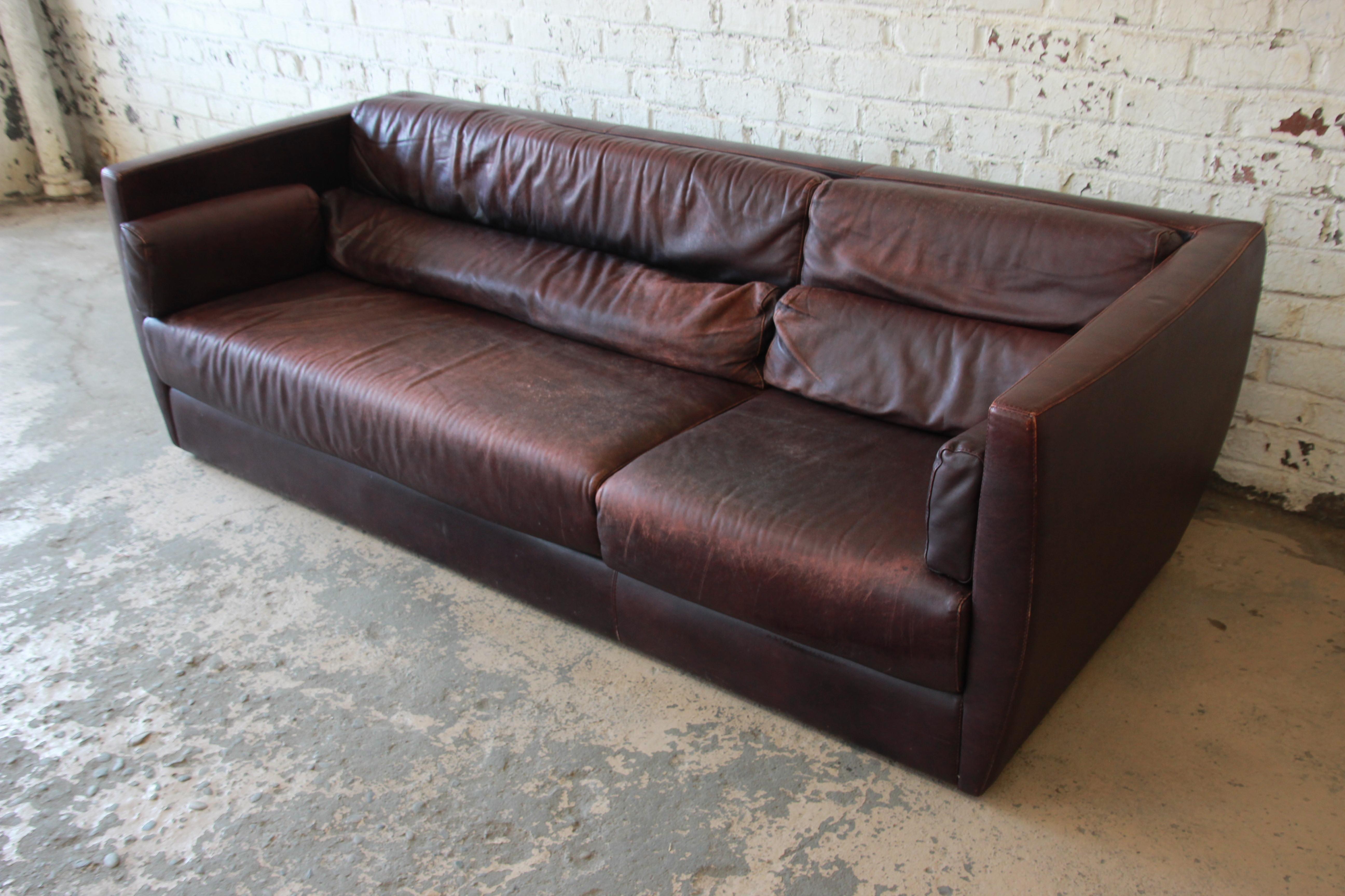 A gorgeous Bauhaus style leather sofa. The sofa was manufactured in Italy, circa 1970 by Tre Erre for Roche Bobois. It features gorgeous high-end leather in a deep burgundy, with a nice patina that only adds to the character and age of the piece.