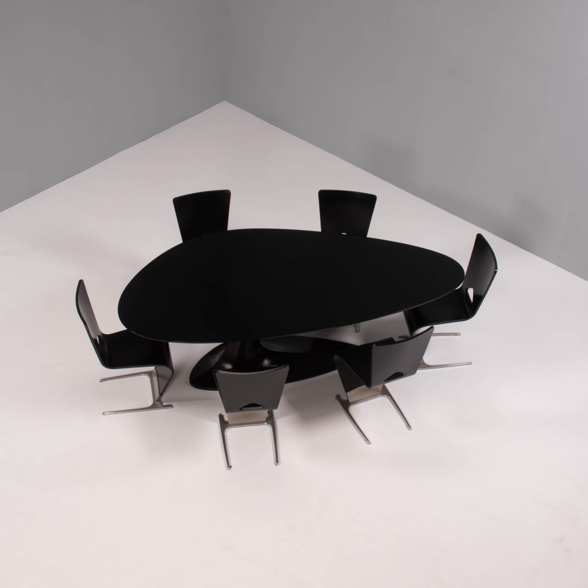 Designed by Sacha Lakic for Roche Bobois, the ‘Speed Up’ collection was a limited edition series inspired by movement, asymmetry and speed.

The dining table features an elliptical black glass top, sitting on a single black fibre-resin pedestal