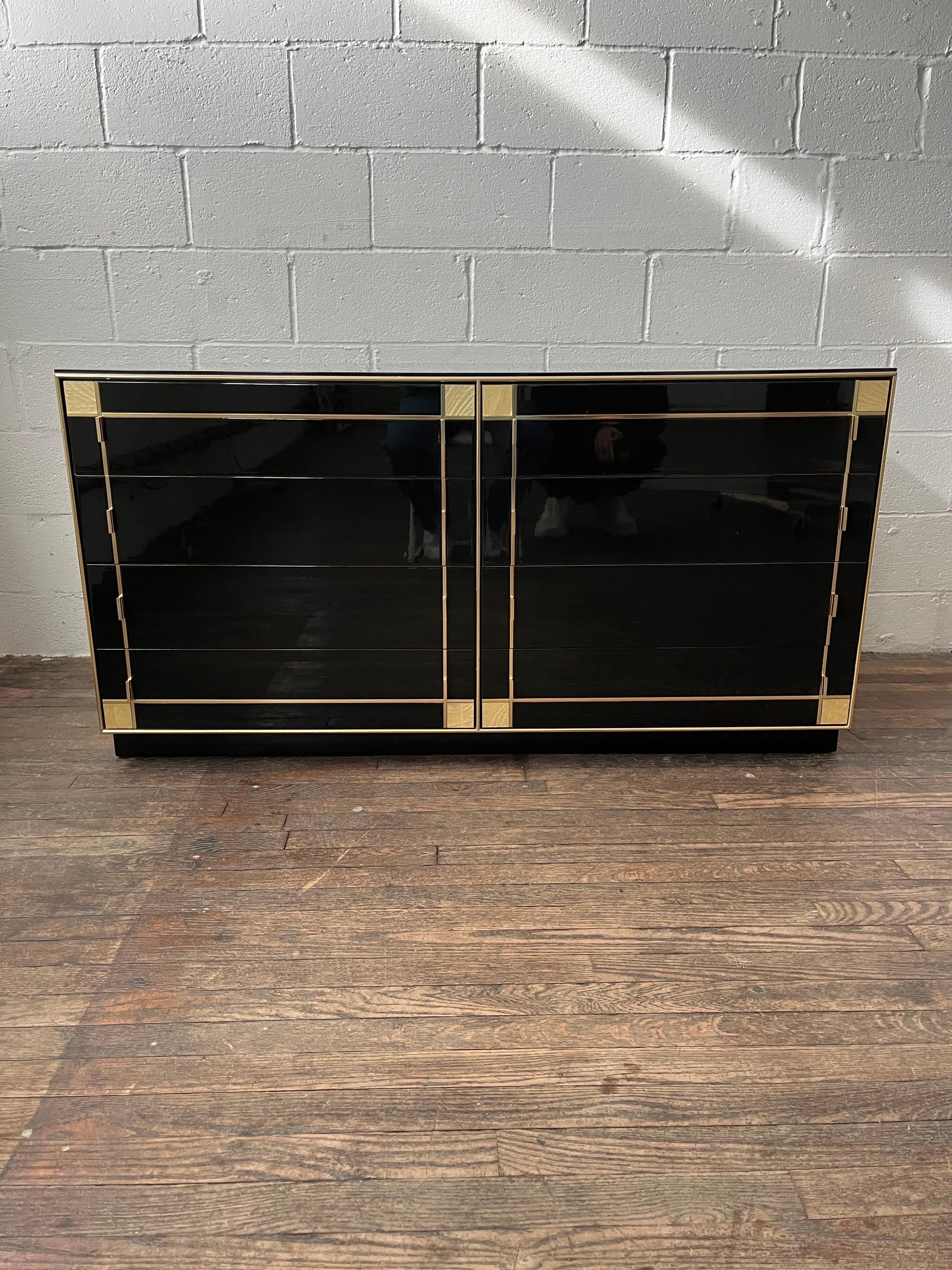 French black Lacquered 8 drawer dresser by Pierre Cardin. Manufactured by Roche Bobois. This piece features gilt brass trim throughout. The strong craftsmanship combined with the elegant lines add a sleek touch to any storage solution.
Nightstands