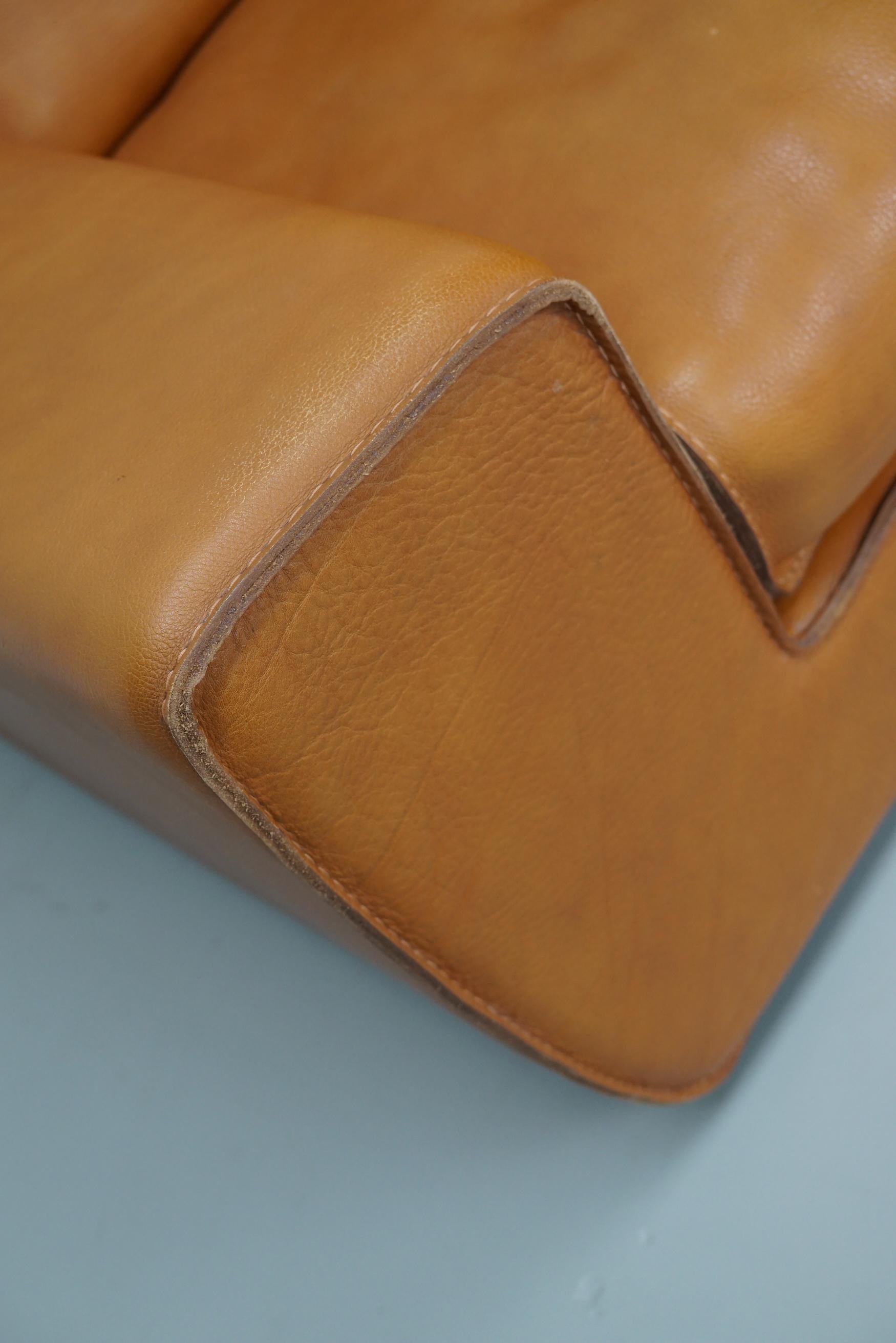 This club chair was designed and made around the 1980s in France from very thick neck leather and reminds of De Sede quality. It is very comfortable and only shows minimal signs of use and age.