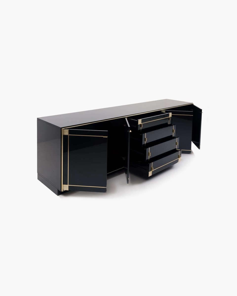 French black. Lacquered credenza by Pierre Cardin. Manufactured by Roche Bobois. This piece features gilt brass trim throughout. The strong craftsmanship combined with the elegant lines add a sleek touch to any storage solution.

  

Founded in