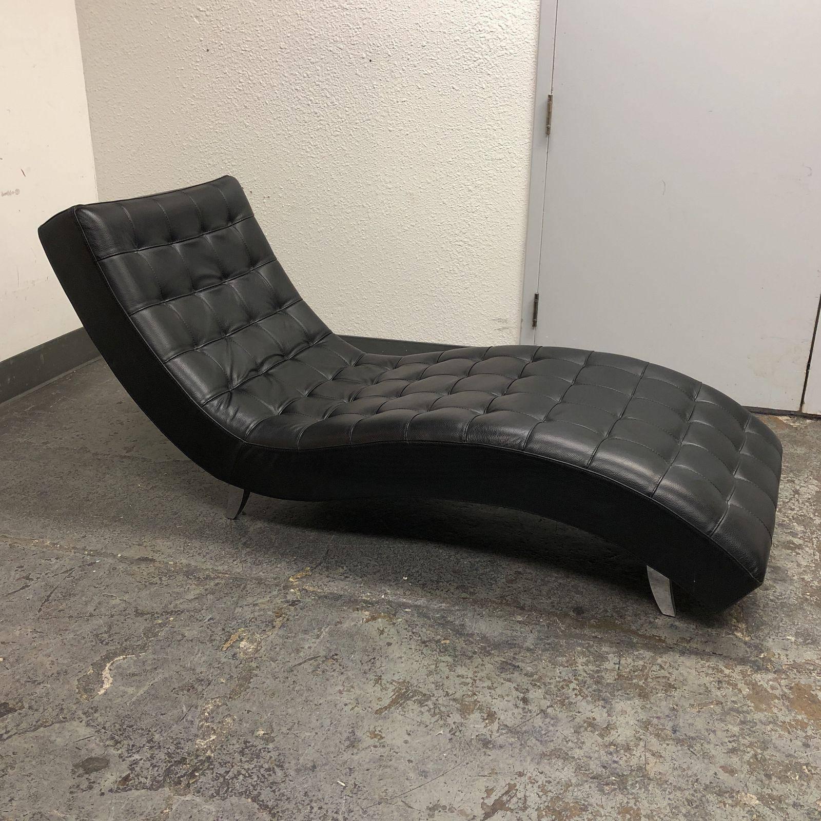 A Dolce lounge chair by Roche Bobois. Upholstered in a black leather. The seat in HR Foam, structure in laminated wood and fir wood. Elastic straps. Base in satin finish aluminum. Measure: Seat height 16 inches. Made in Italy.
 