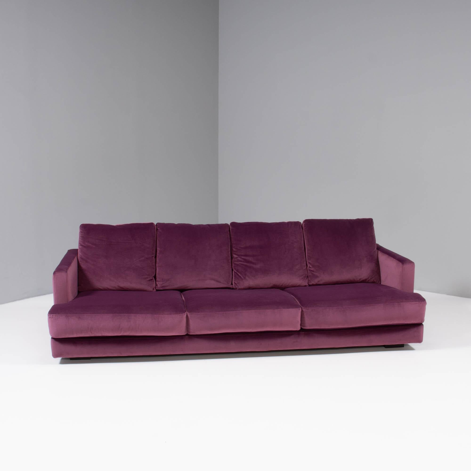 Designed by Roche Bobois, this Eclipse sofa is a timeless design.

The slimline frame sits on wooden block feet, giving the illusion that the sofa is floating above the floor.

Newly upholstered in deep purple velvet fabric, the sofa features