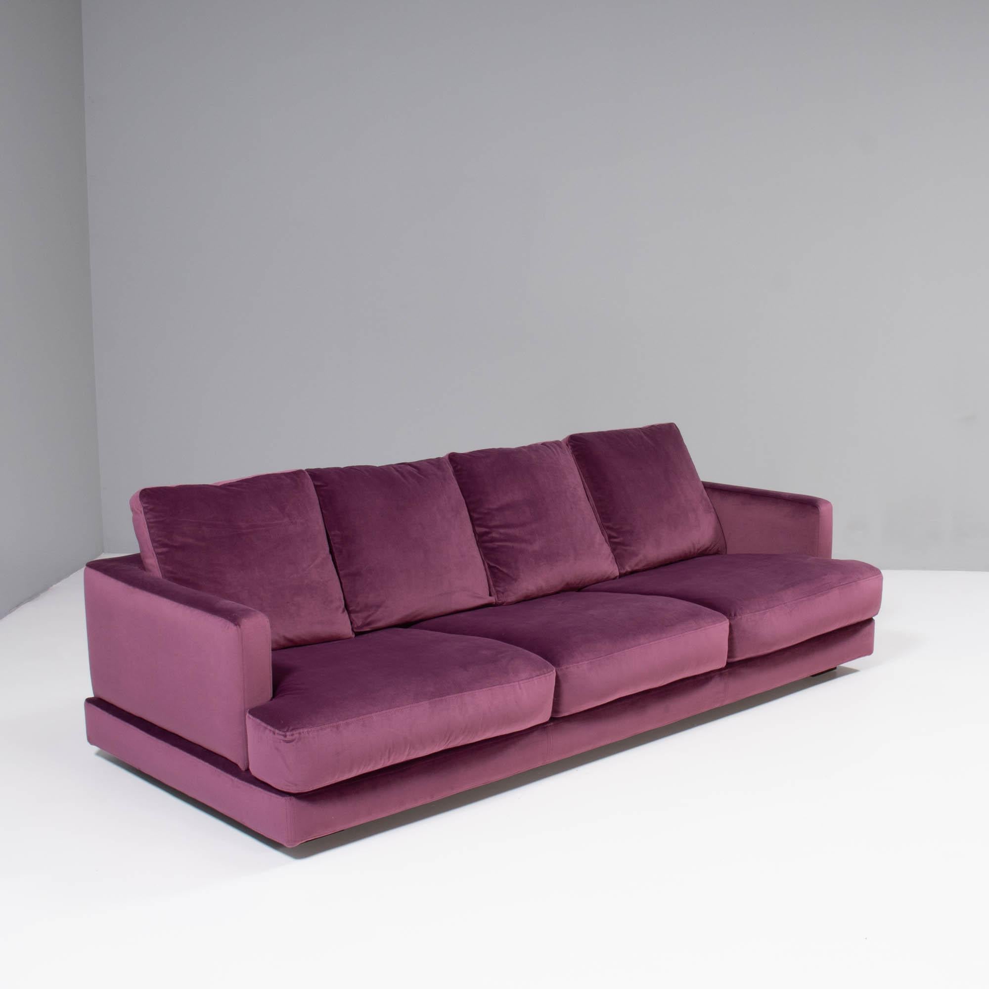 Designed by Roche Bobois, this Eclipse sofa is a timeless design.

The slimline frame sits on wooden block feet, giving the illusion that the sofa is floating above the floor.

Newly upholstered in deep purple velvet fabric, the sofa features