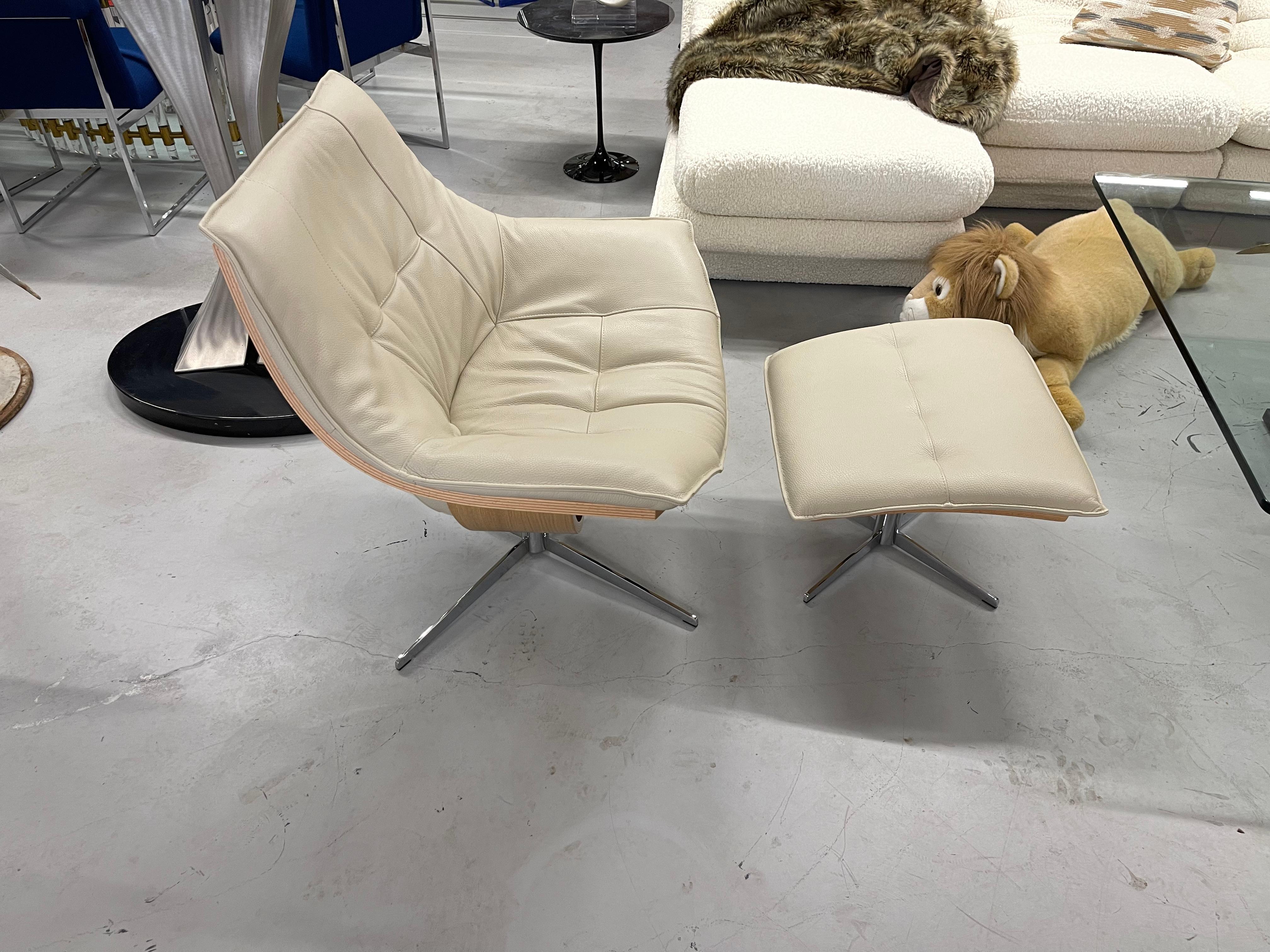 Beautiful Roche Bobois flight chair and ottoman. This lovely and extremely comfortable chair is in excellent condition with very minor wear. Purchased within the last few years, it is a pretty shade of off white. Ottoman measures 23x20 inches and 14