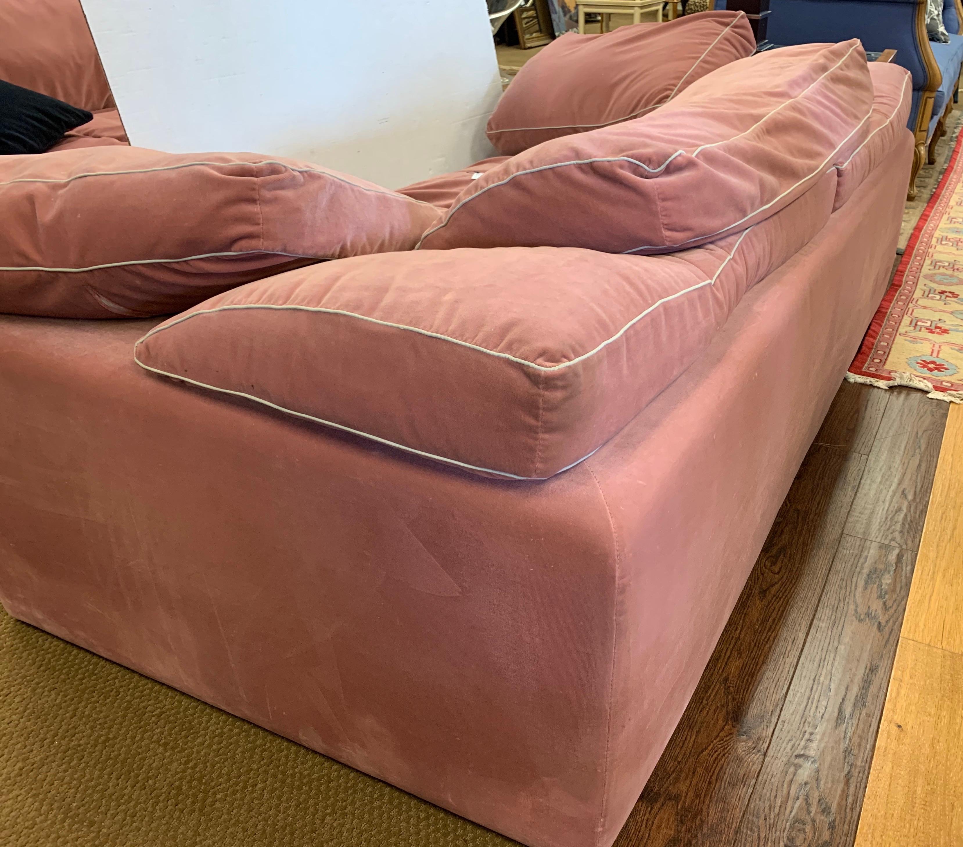 Postmodern signed Roche Bobois Furniture loveseat, circa 1990s, this piece features an extraordinary pale pink velvet fabric that is both luxurious and compelling. This is a low profile piece that is very comfortable and comes, as shown in pictures,