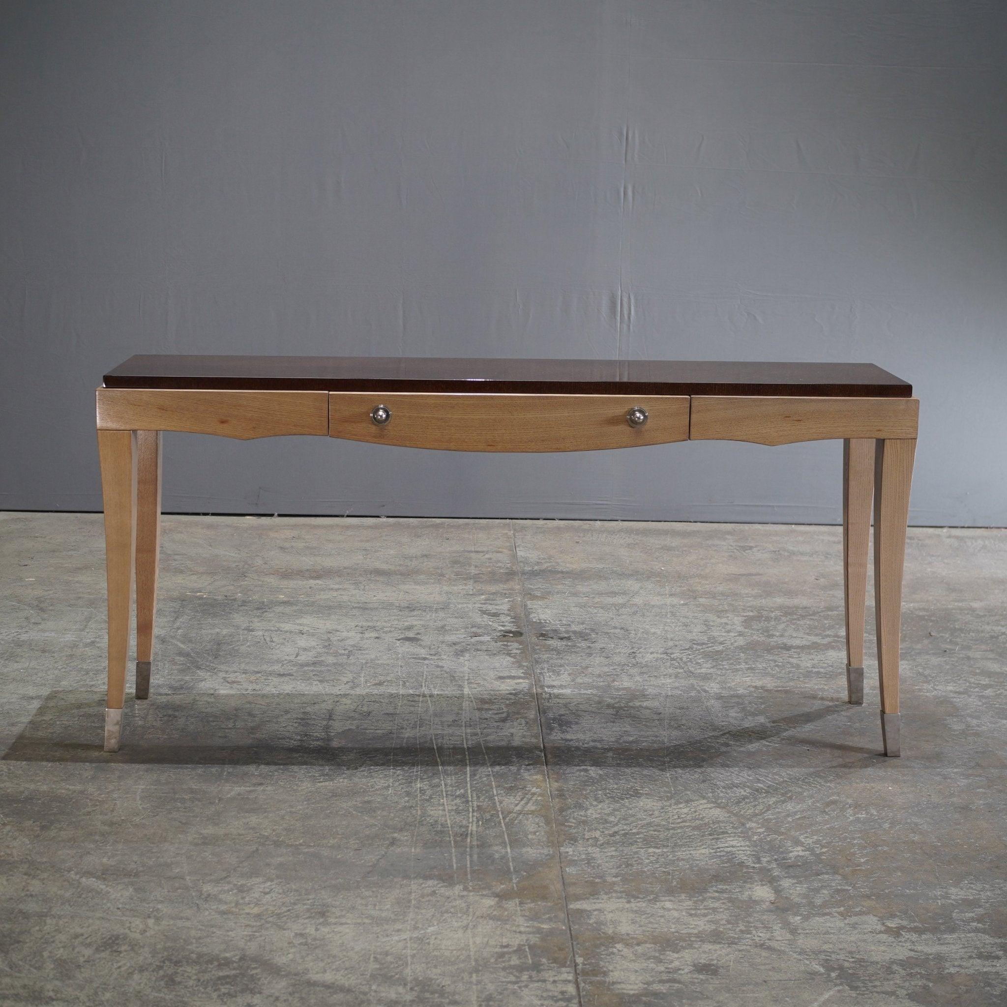 The Roche Bobois Grand Hotel Console Table, designed by Pierre Dubois & Aimé Cécil, exemplifies elegance and sophistication. This console table combines a rich wood finish with sleek lines, creating a piece that is both functional and visually