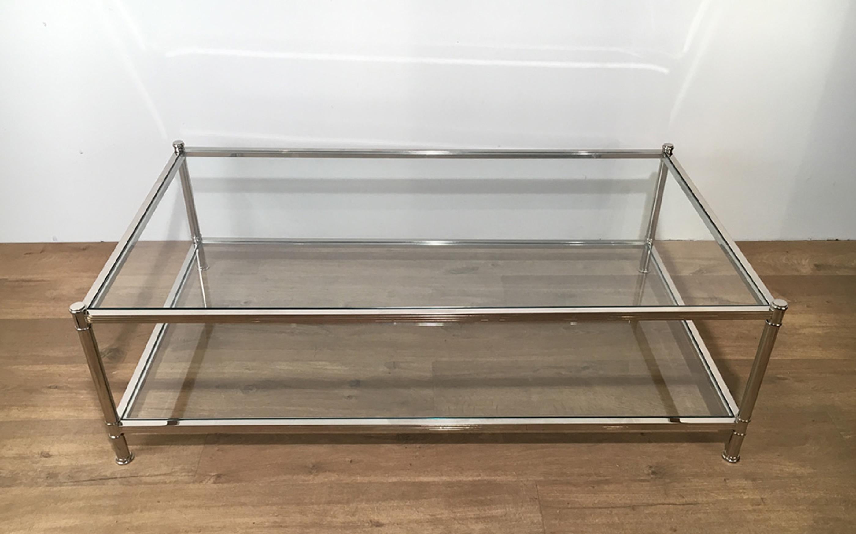 This large coffee table is made of chrome. This is a vintage cocktail table of very good quality with 2 clear glass shelves. This is a model by famous French maker Roche Bobois, Circa 1970.
