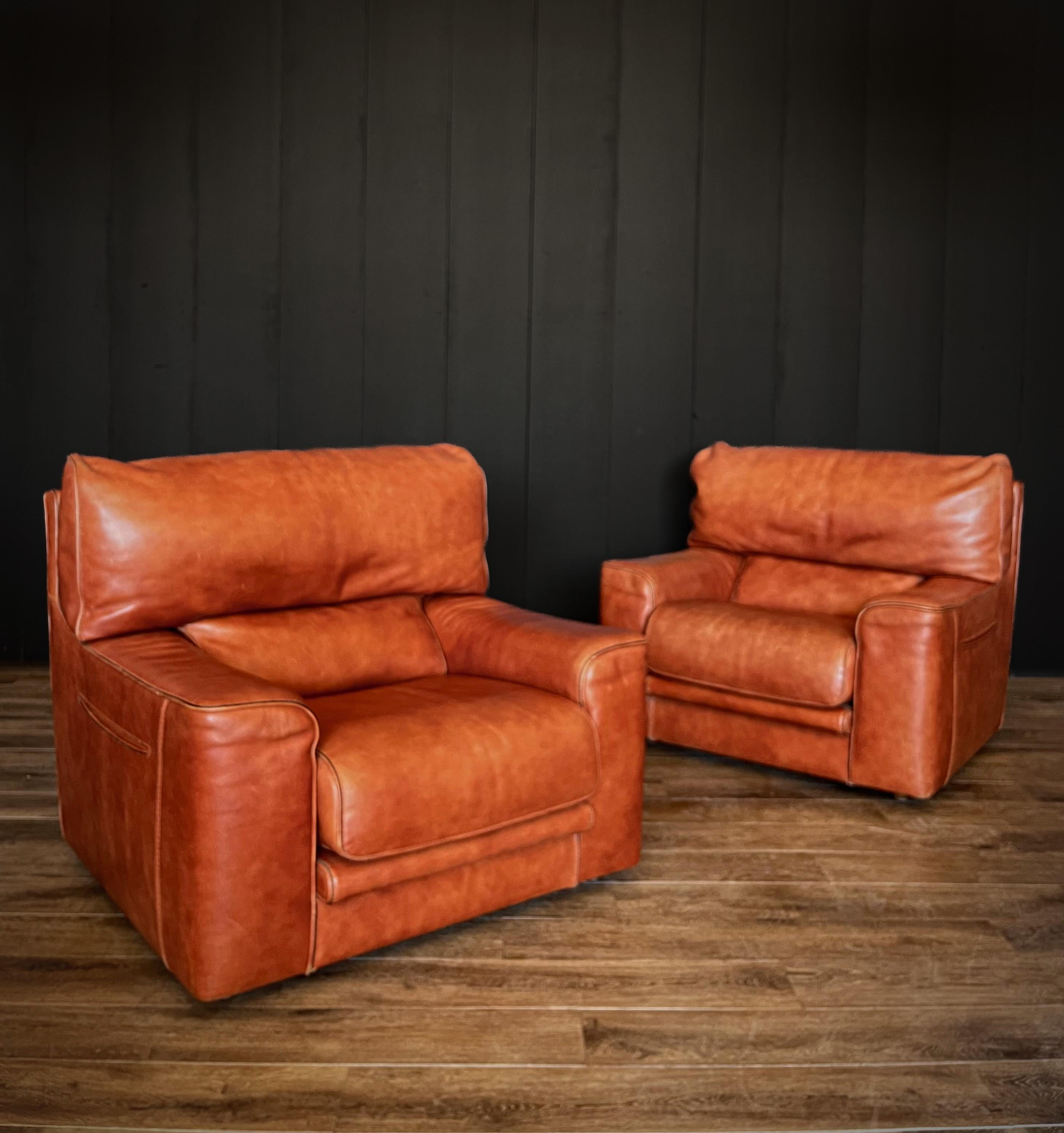 Experience vintage luxury with this pair of Roche Bobois Leather Lounge Chairs. These chairs, crafted with precision, offer timeless style and clever functionality. Adorned in premium leather, they radiate elegance and lasting comfort. What makes
