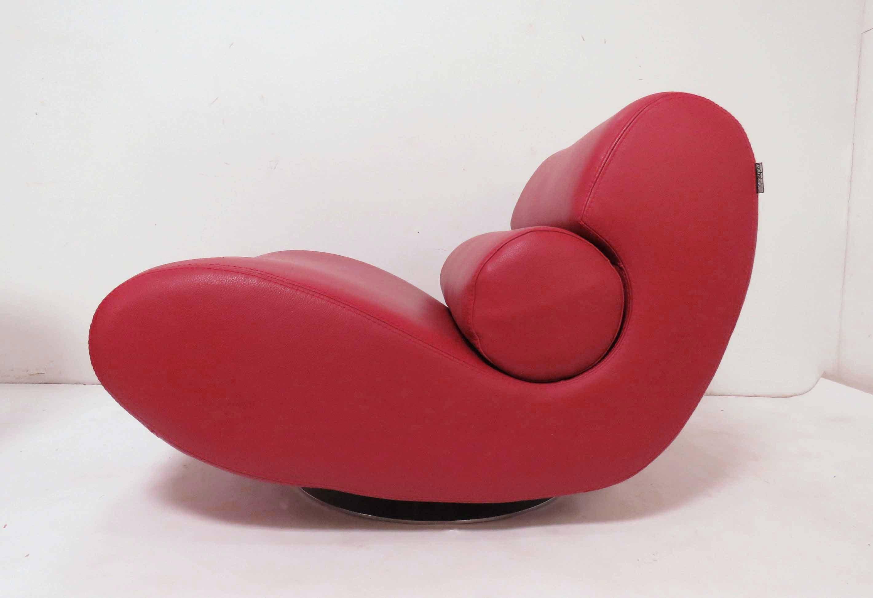 A Postmodern swivel lounge chair in red leather, by Roche Bobois, made in Italy. With matching bean bag ottoman.

Lounge chair measures 34