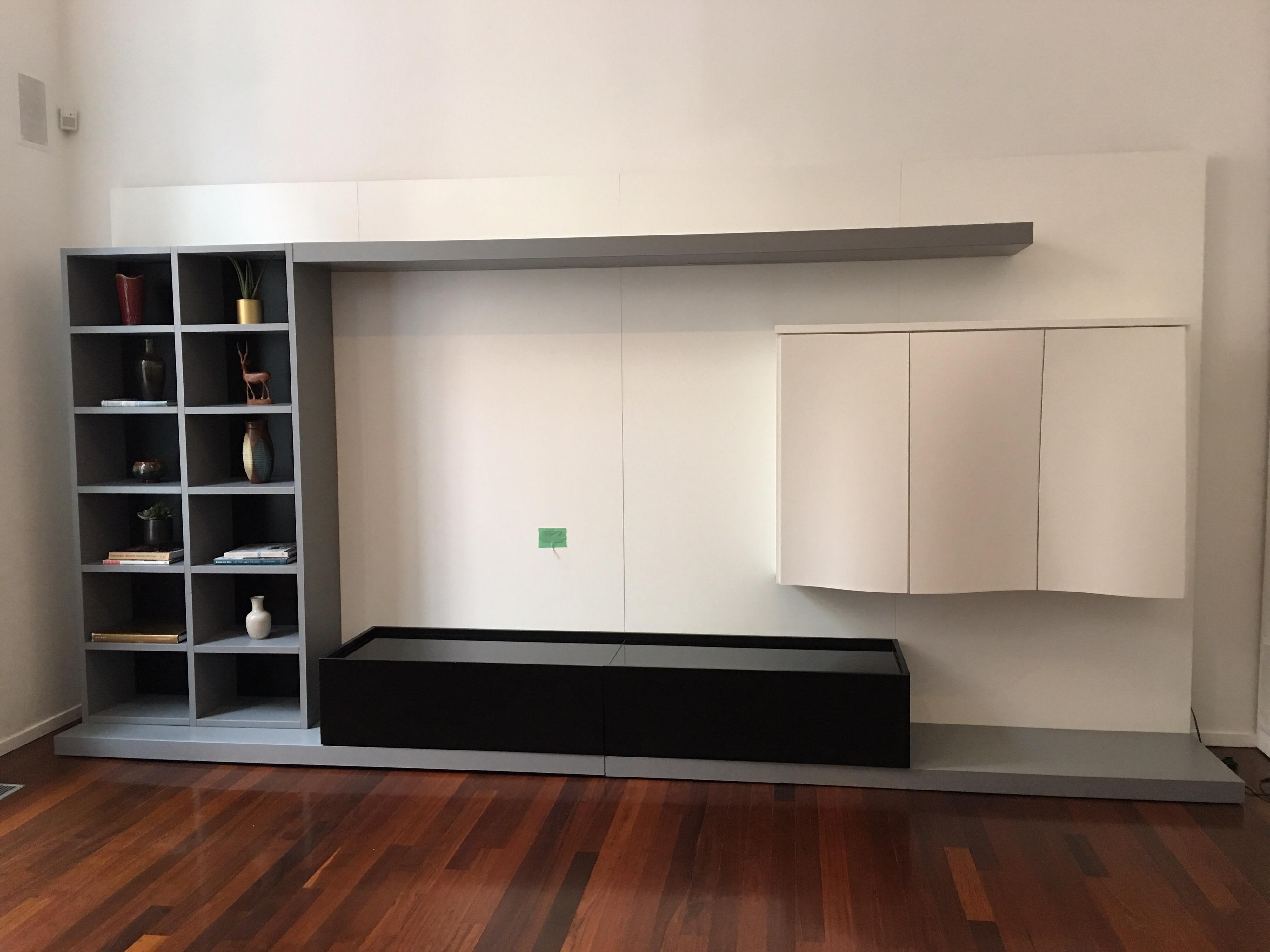 Roche Bobois media center/ wall unit with cabinets for storage and shelving. Handsome unit with plenty of storage options, and a great spot for that TV! Green box on wall is the cable box.