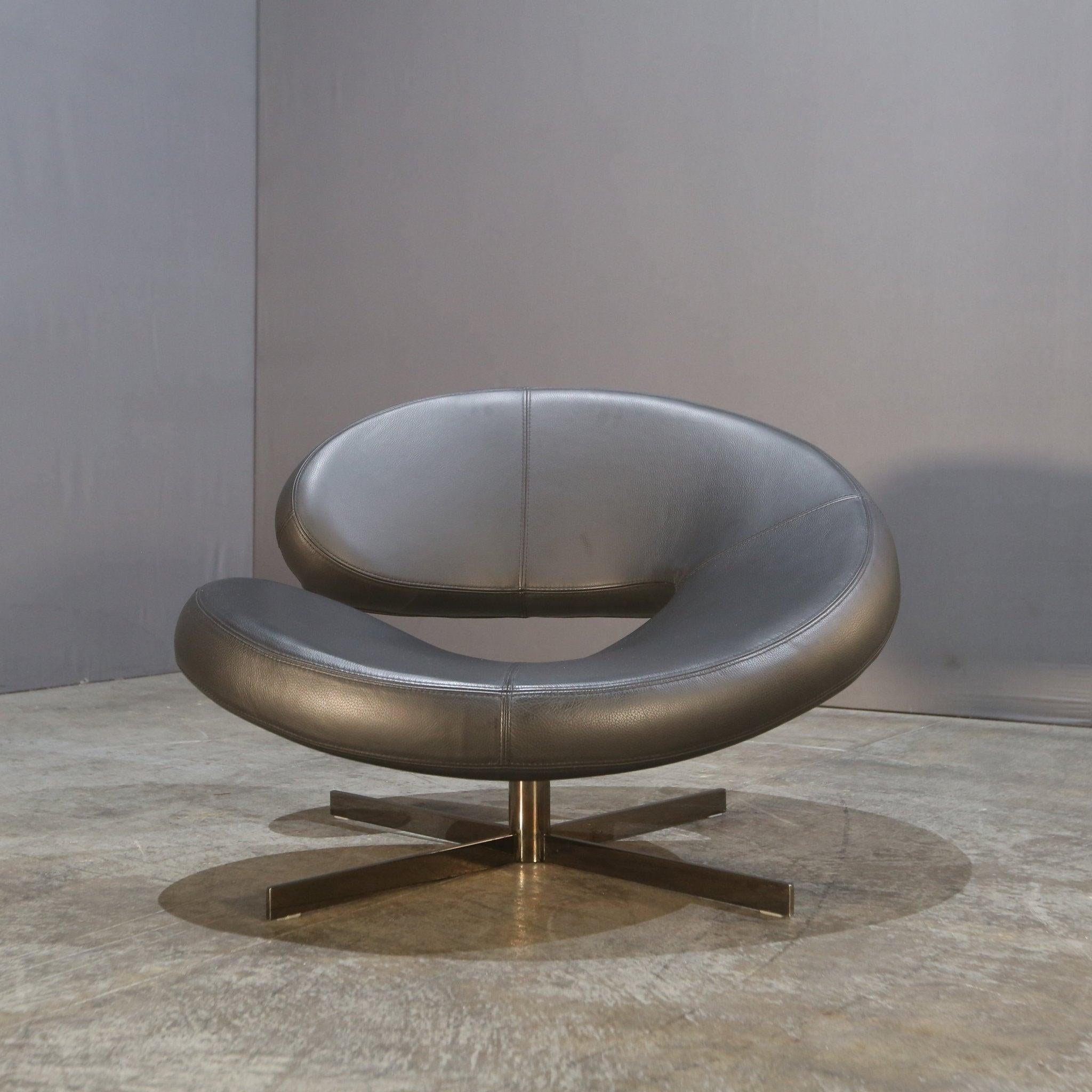 Introducing the Nuage 2 Armchair by Roche Bobois, a stunning addition to any luxury living space. This armchair features a sleek and modern design, with a curved backrest and two elegant arms. The frame is made of high-quality metal, while the seat