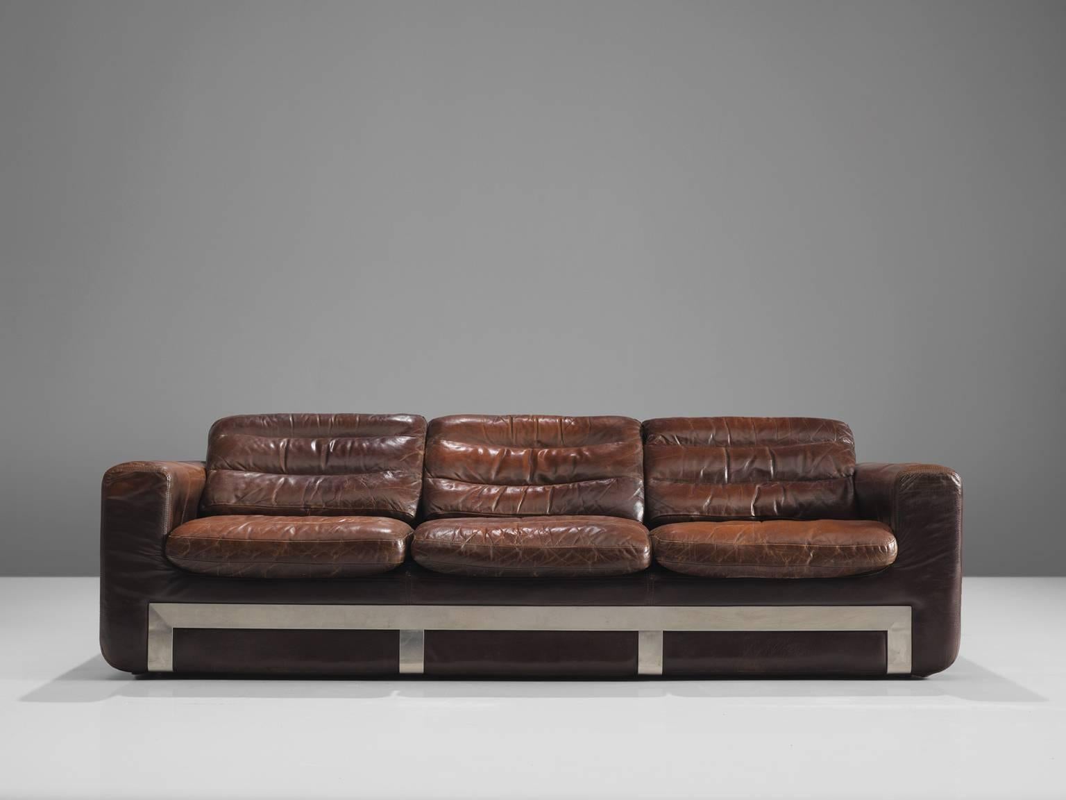 Roche Bobois, sofa, leather and steel, France, circa 1970. 

This comfortable sturdy leather and metal sofa is designed and made by Roche Bobois. As for much of Bobois' furniture it showed traits of the aesthetics by Airborne, Bauhaus and other