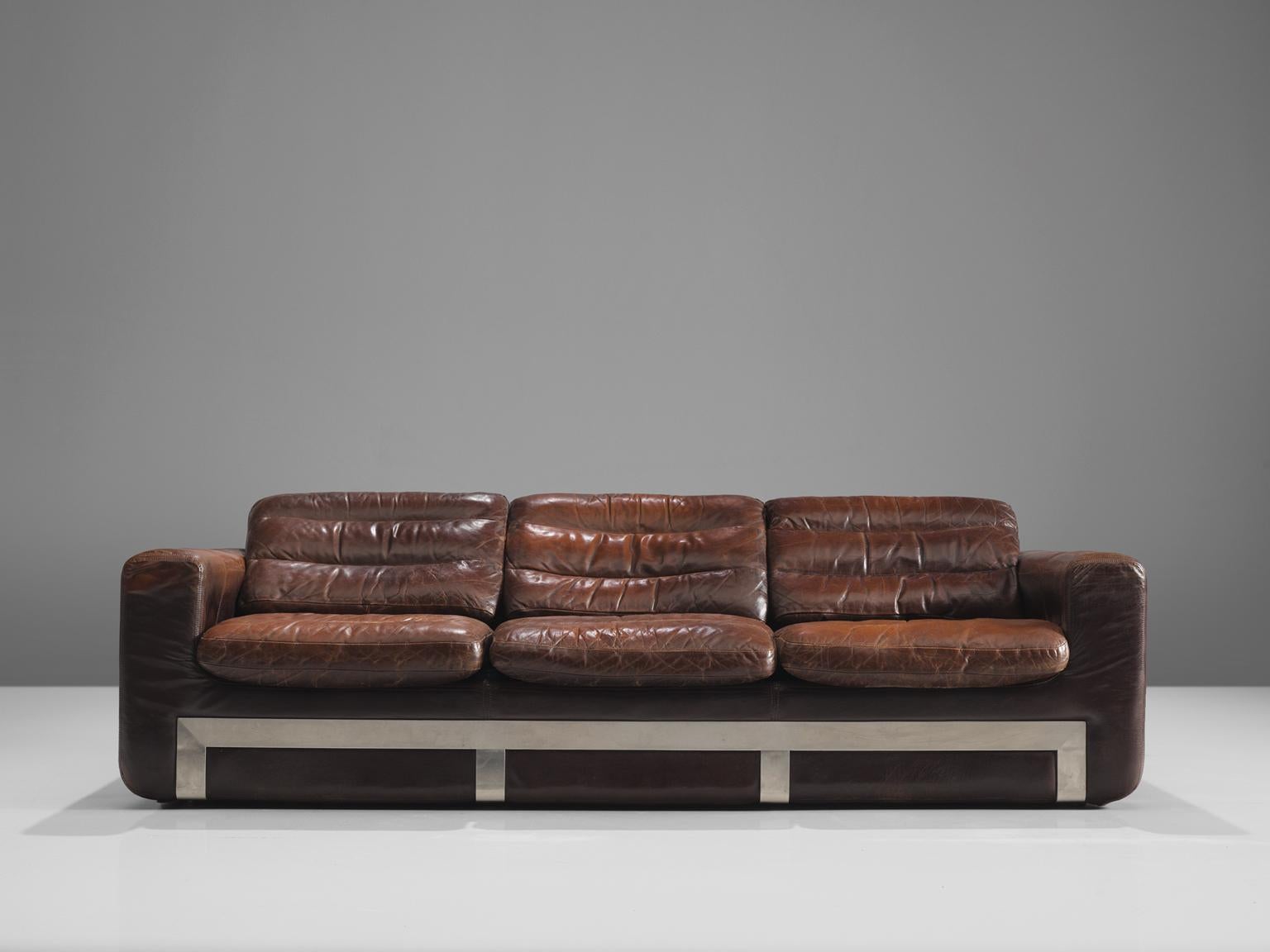 Roche Bobois, sofa, leather and steel, France, circa 1970. 

This comfortable sturdy leather and metal sofa is designed and made by Roche Bobois. As for much of Bobois' furniture it shows traits of the aesthetics by Airborne, Bauhaus and other