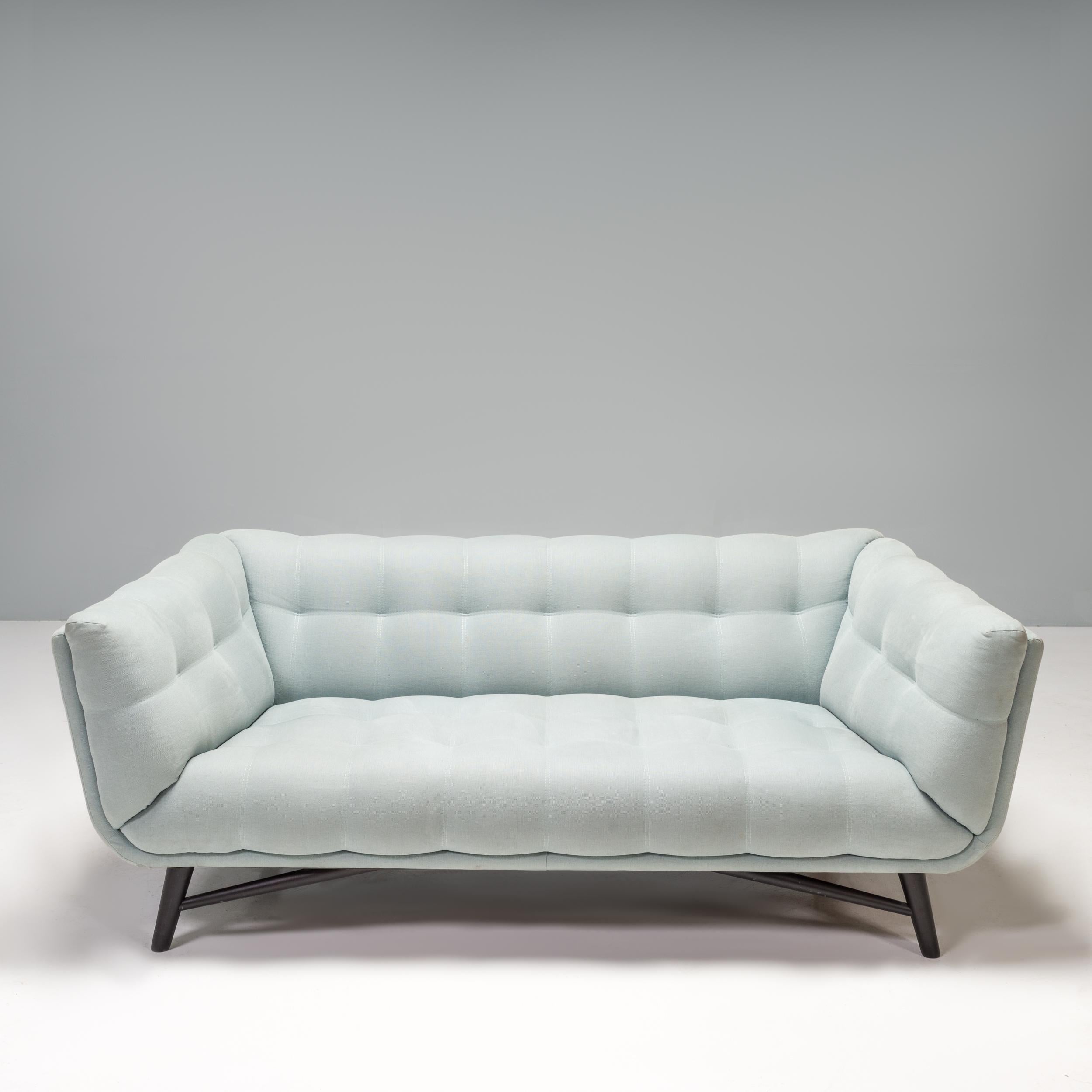 Designed by Roberto Tapinassi and Maurizio Manzoni for Roche Bobois, the Profile sofa offers a contemporary update on the classic Mid-Century Tuxedo style.

Constructed from a fir wood and pine ply structure, the sofa sits on four angular legs in