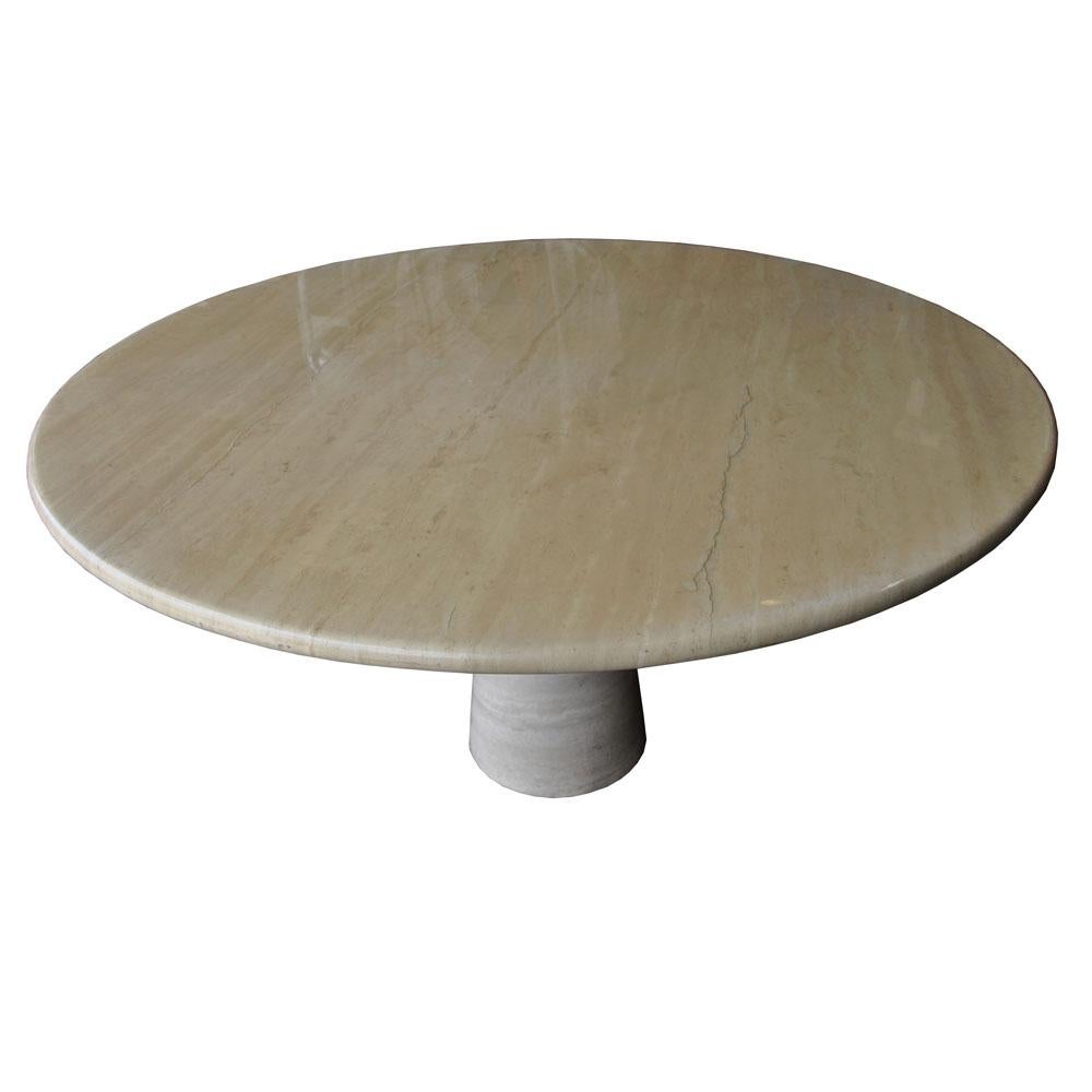 A contemporary dining table from Roche Bobois. The table of polished travertine marble with a conical base and 1 1/4