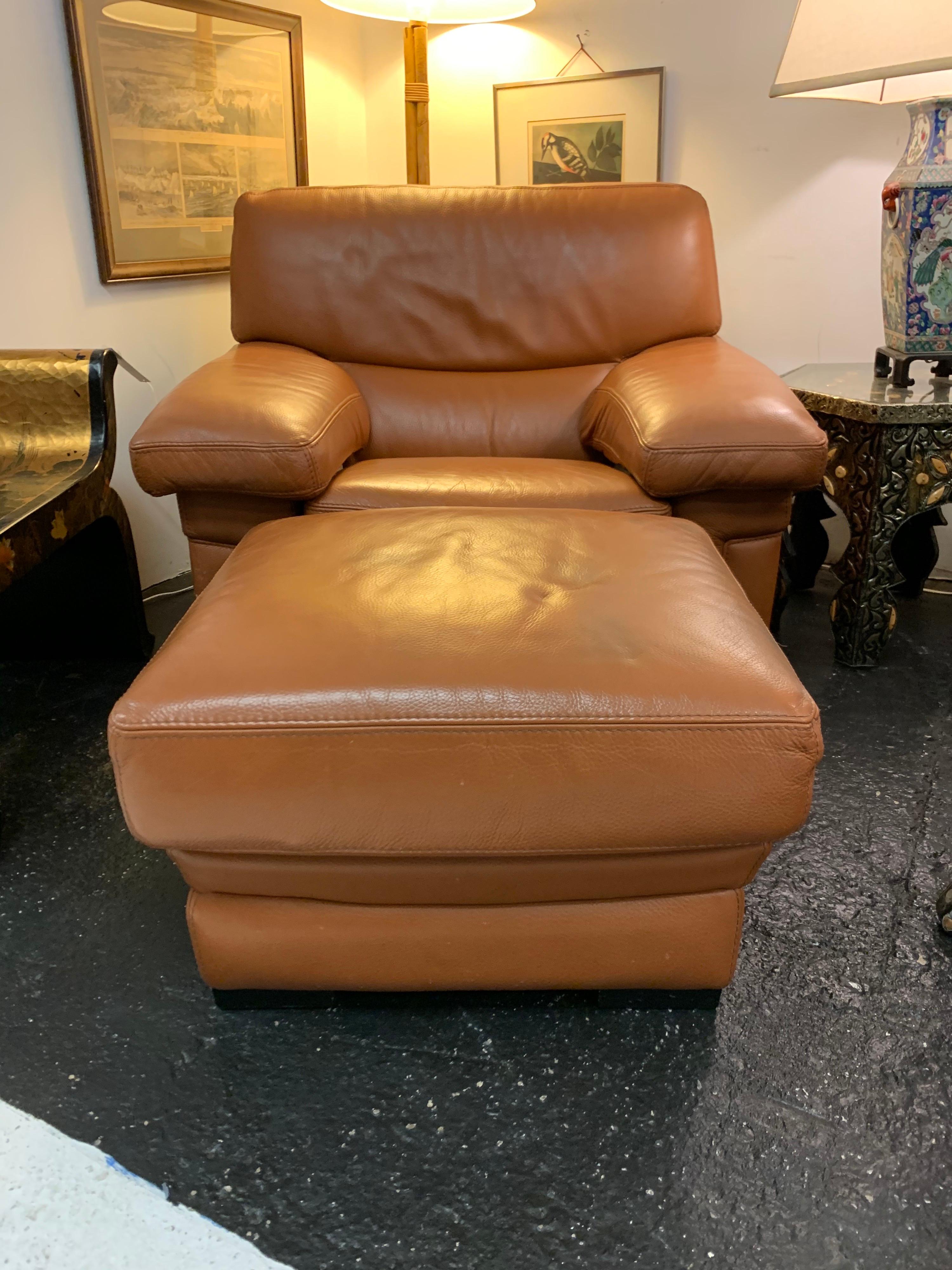 Made in France by the esteemed maker Roche Bobois is this post modern large brown pebbled leather chair with matching ottoman. The ottoman measure 24 x 24 x 15 inches tall and the chair dimensions are below.
