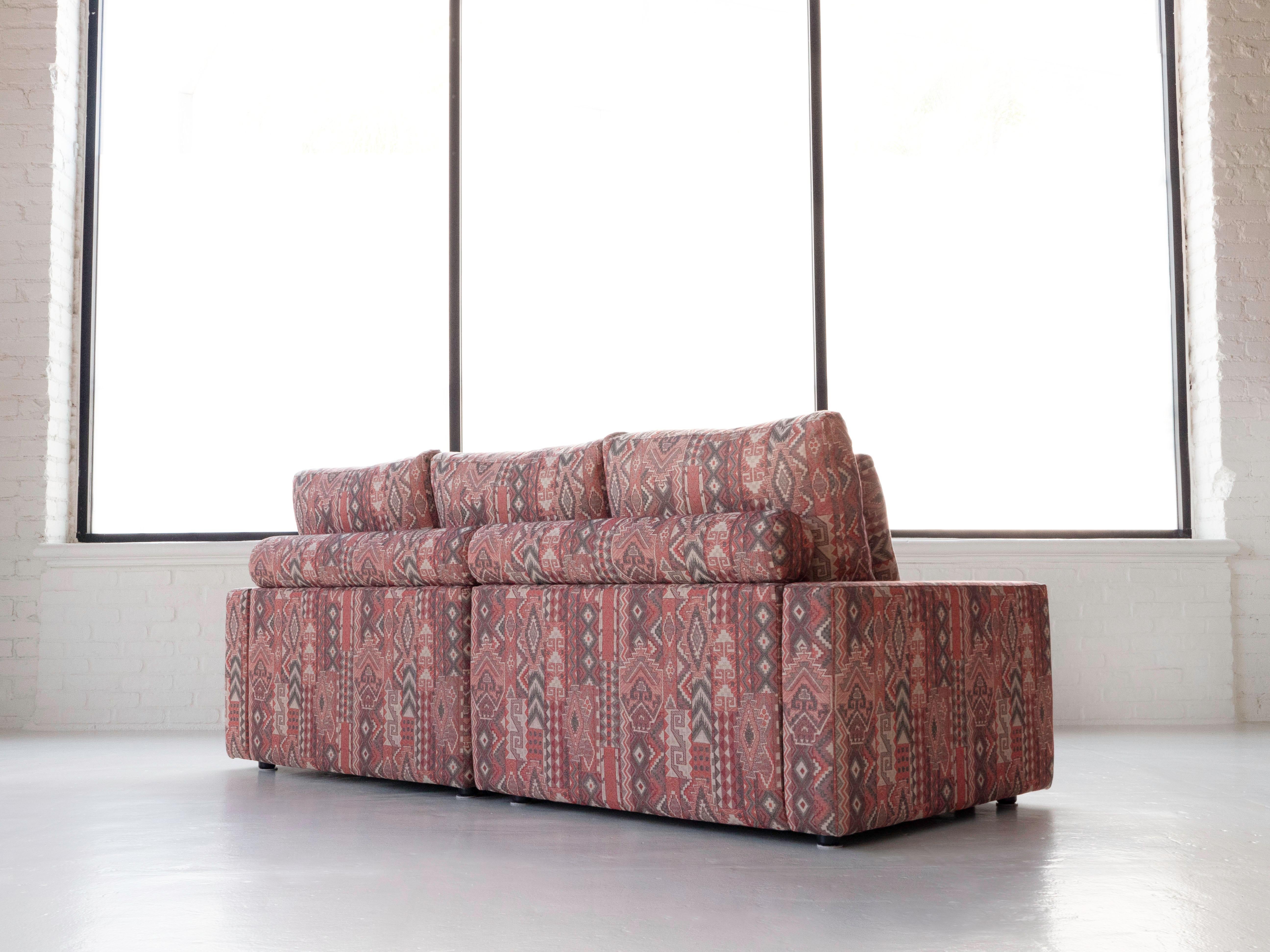 Roche Bobois three-seat sofa & ottoman by designer Hans Hopfer in like new condition. The sofa was manufactured in 1987 per tags shown underneath. Original 100% cotton fabric with an intricate pattern. The back cushions are down filled. The seat