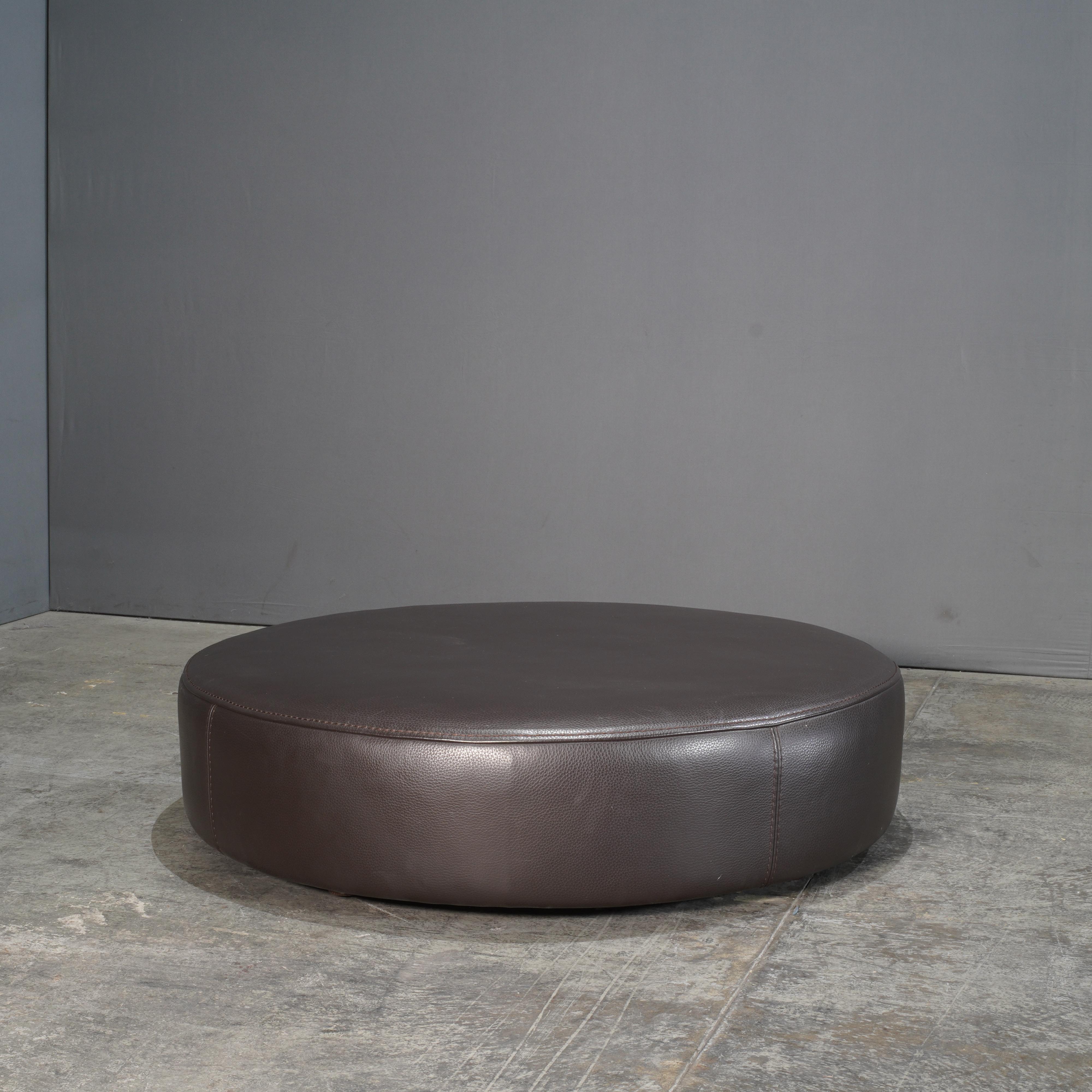 The Roche Bobois Solstice Leather Ottoman by Philippe Bouix is a striking blend of modern design and supreme comfort. Upholstered in rich, dark chocolate leather, this ottoman exudes luxury and sophistication. Its rounded form creates a soft and