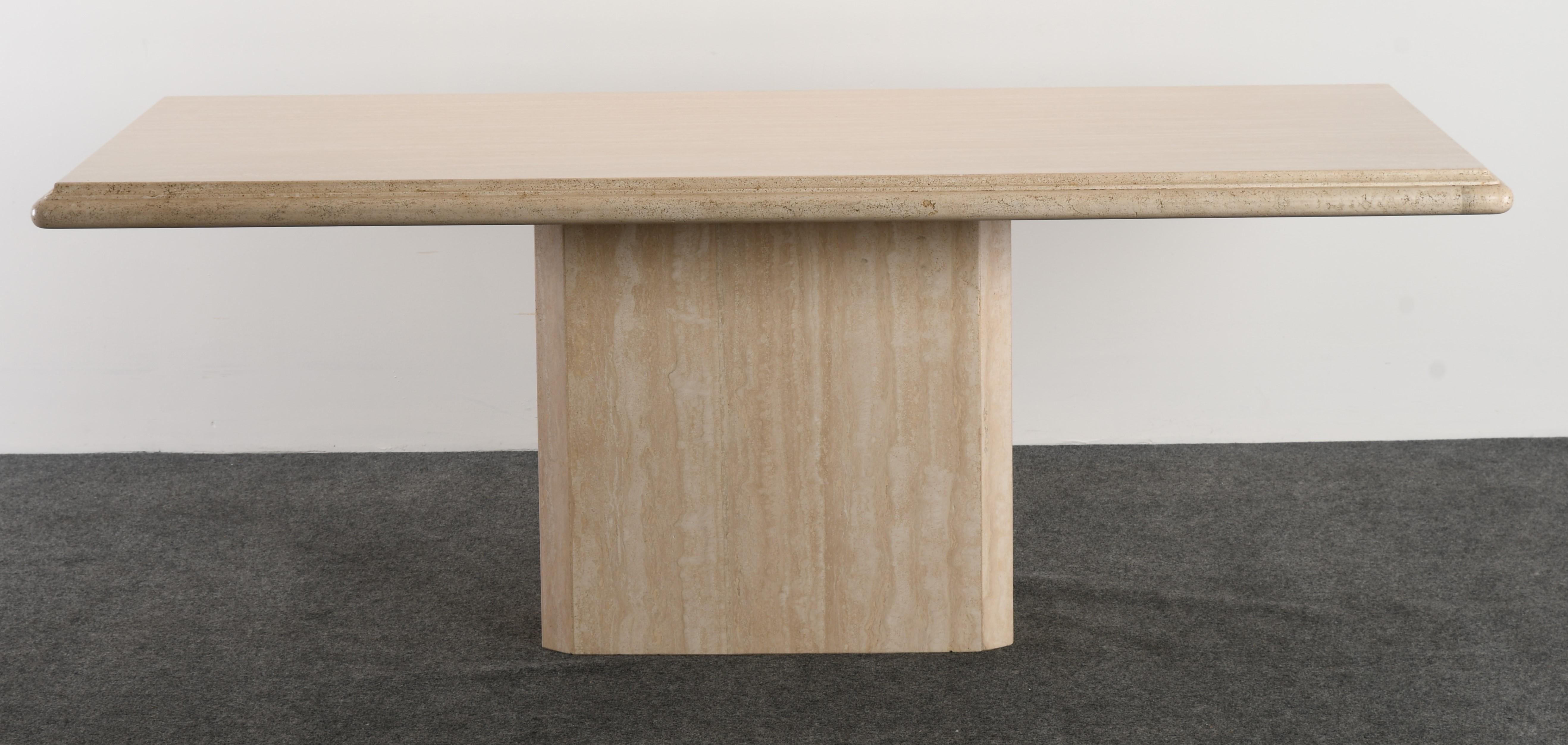 A stunning Roche Bobois style travertine dining table with a beveled edge. The table is structurally sound and in good condition with age-appropriate wear.

Dimensions: 29.5