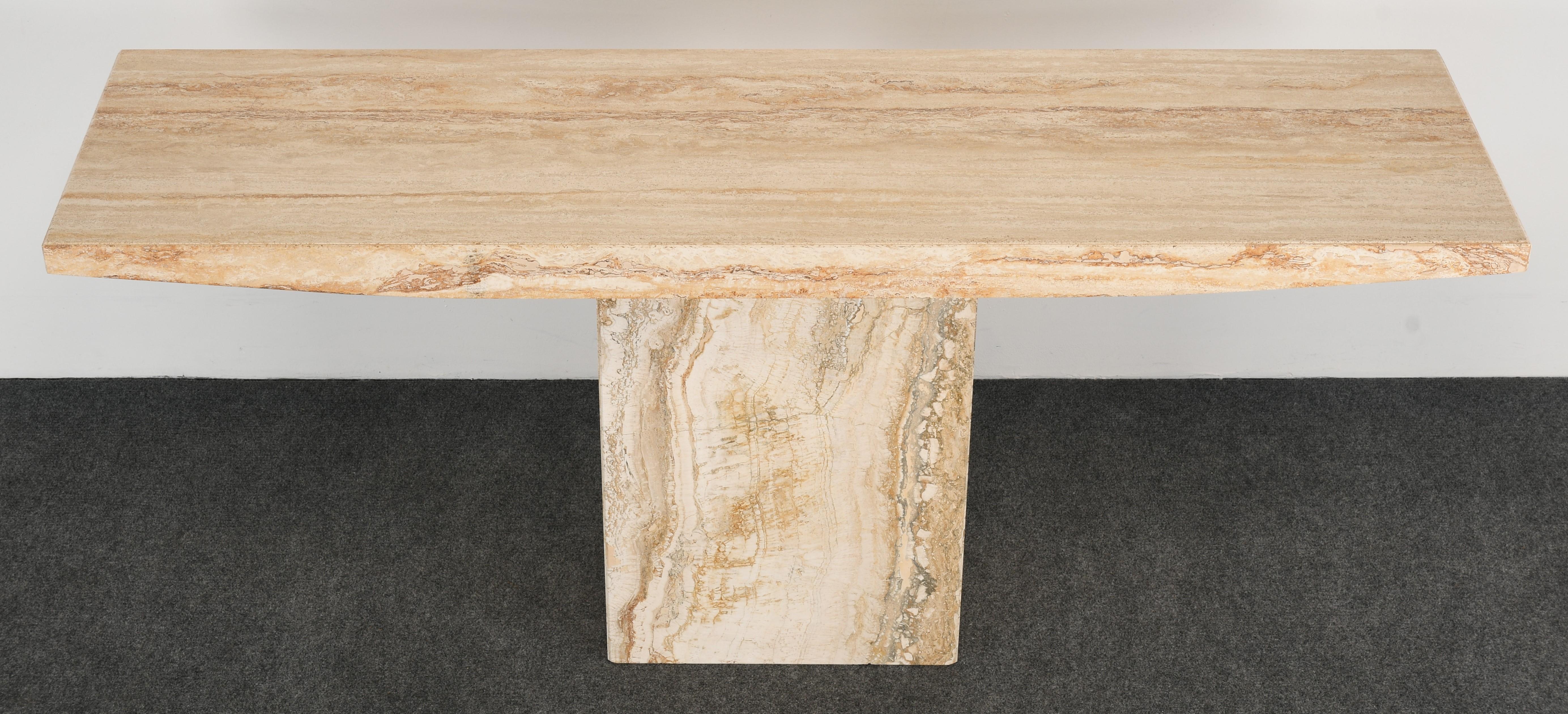 A Minimalist travertine console table in the manner of Stone International or Roche Bobois. This console table has wonderful modern lines as well naturalist color and veining. This table is structurally sound and in very good condition with