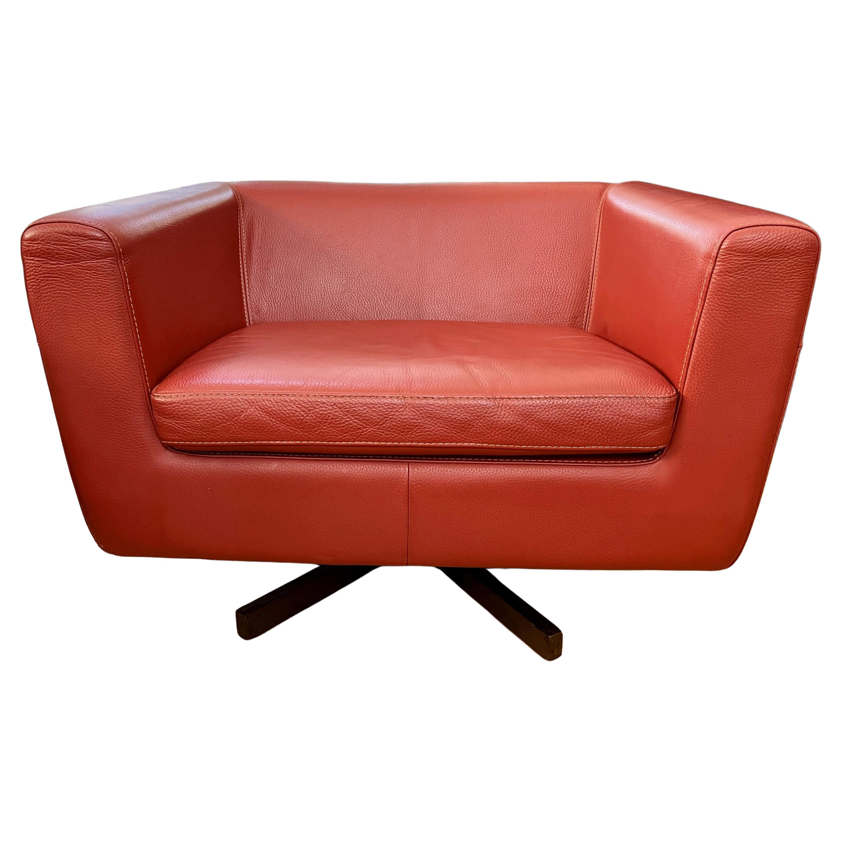 Roche Bobois Swivel Armchair features Brick Red Leather, Contrast Stitching, 360 Degree Rotating Wooden 5 Leg Swivel Base, One Chair Cushion and One Pillow. Very comfortable deep seating. 