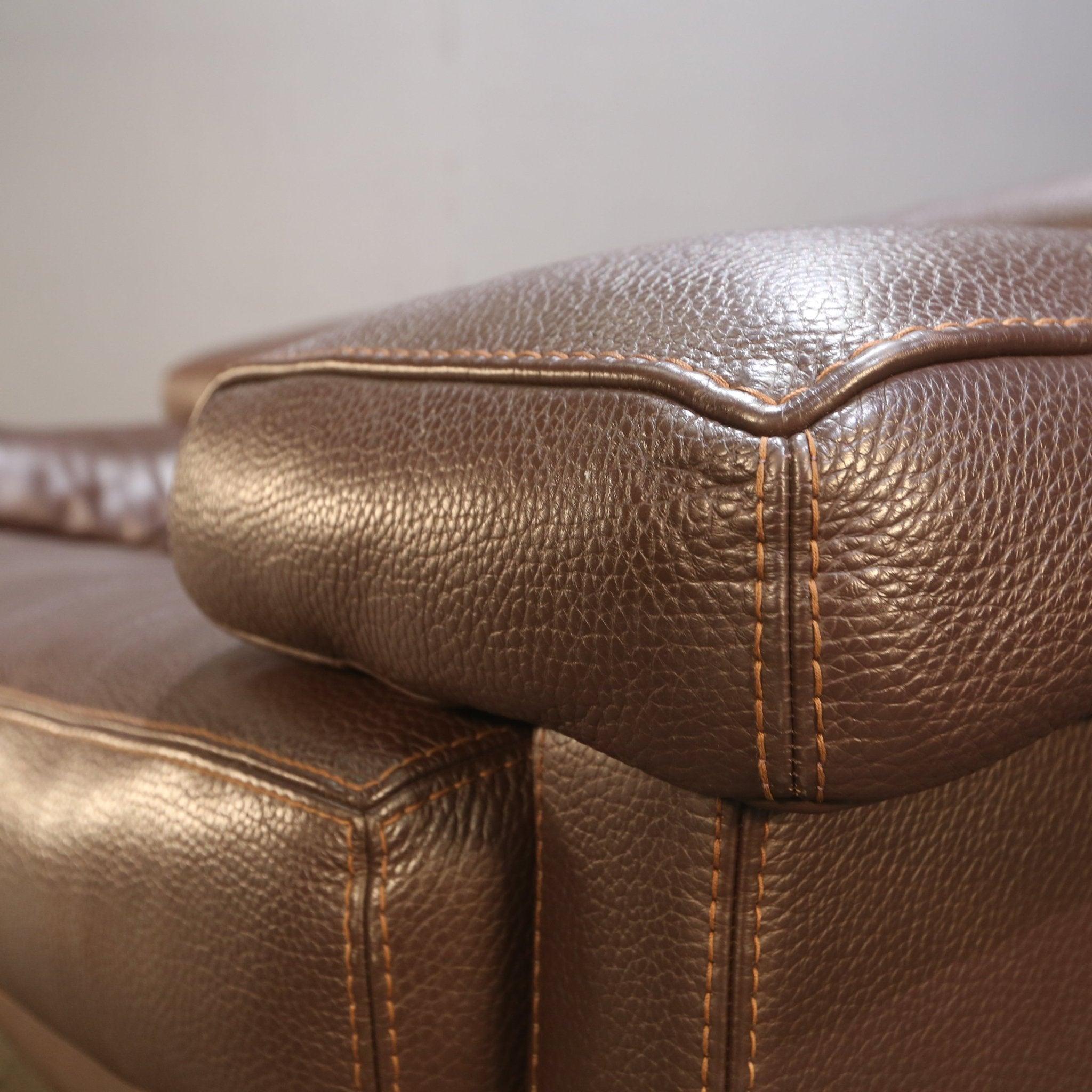 Introduce elegance and sophistication into your living space with the Roche Bobois Three Seater Brown Leather Sofa. Crafted with the finest quality leather, this luxurious sofa boasts a rich brown hue that exudes warmth and style. Its sleek and