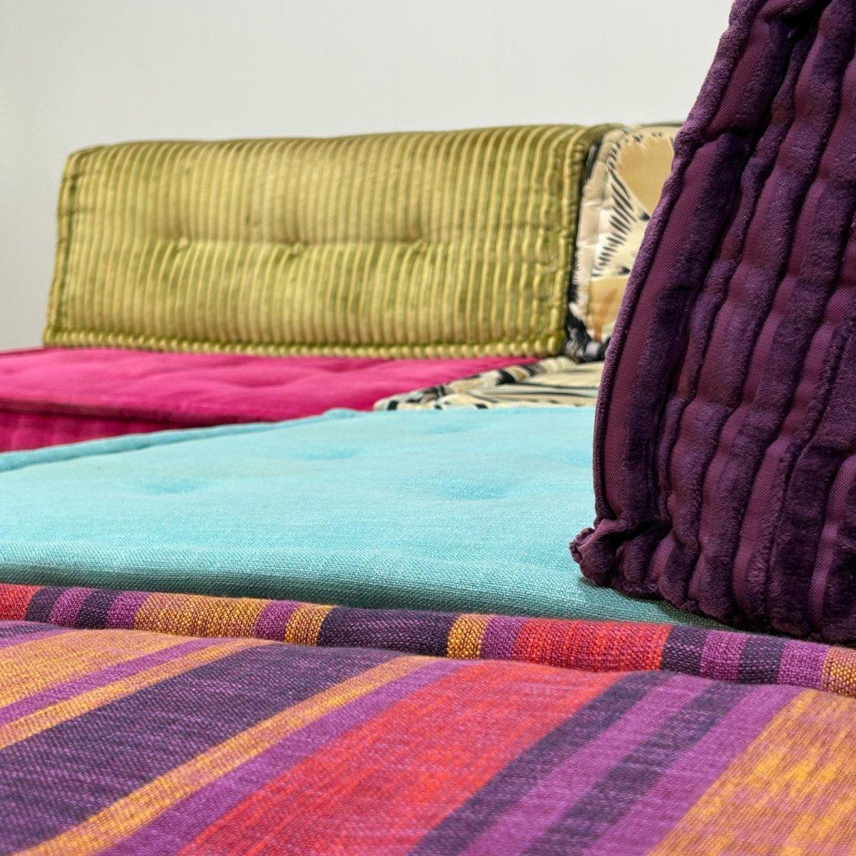 The Roche Bobois Mah Jong Sofa, a design icon by Hans Hopfer, epitomises modular versatility and luxurious comfort. This particular set of twelve has pieces upholstered in either plush cotton velvet or fabric, providing a varied tactile experience.