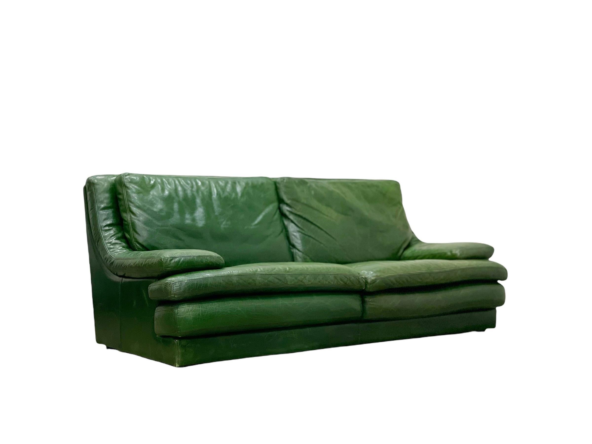 Extraordinary post modern sofa and loveseat by Roche Bobois in green leather. Supreme comfort and unmatched craftsmanship. Aniline dyed British Racing Green (BRG) leather is soft and supple and worn in perfectly. Luxurious stacked cushions and an