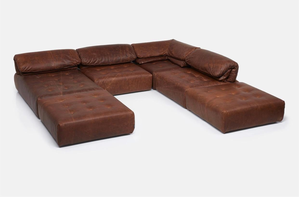 An exceptional and expansive modular sofa by Roche Bobois in thick, distressed, Brazilian leather. The sofa consists of six elements: 1 chaise, 2 single chairs, 1 corner chair, and 2 ottomans. The elements can be arranged in an endless number of