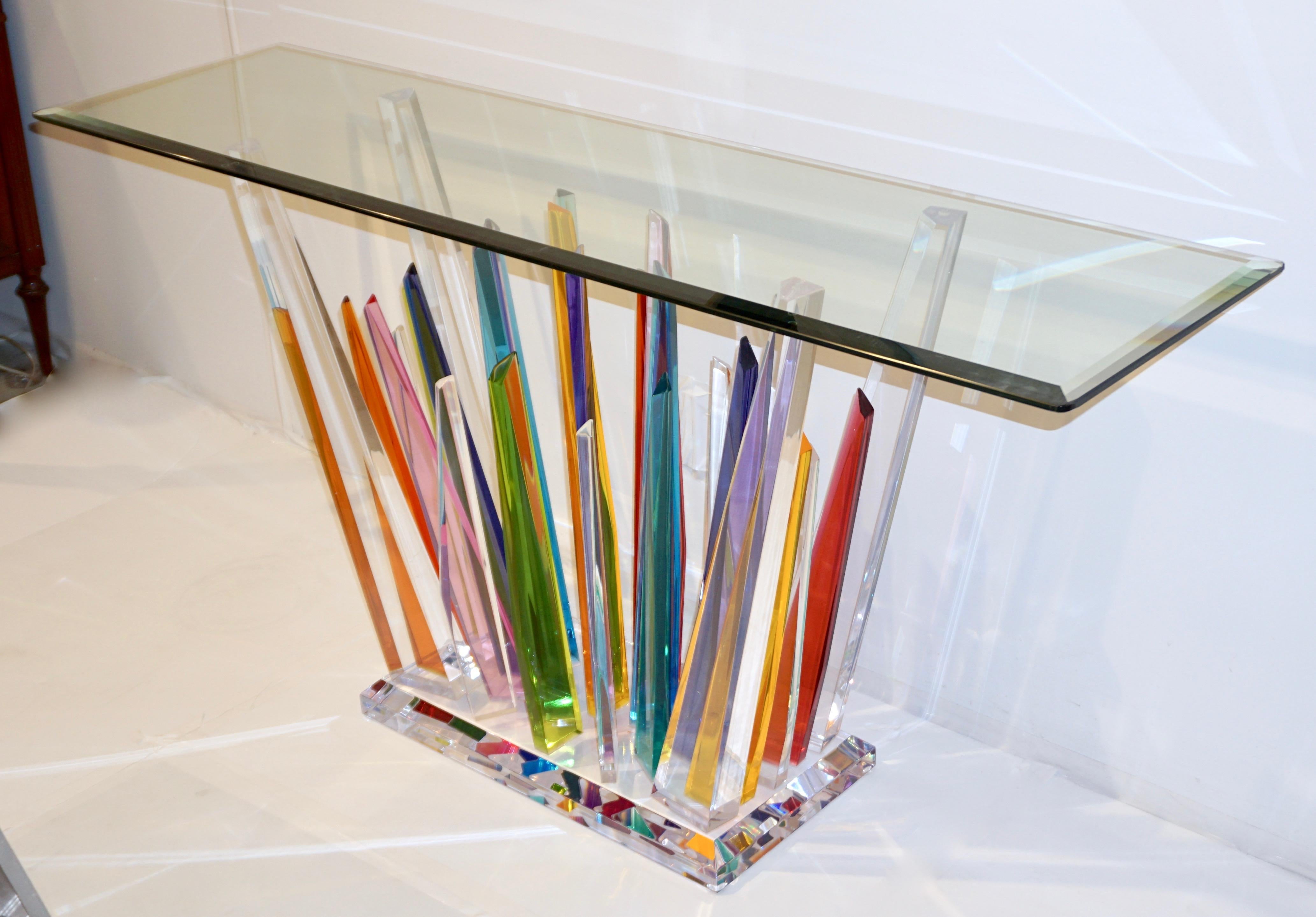 A very attractive and fun contemporary central or wall console table in high quality multicolored plexiglass that looks like rock glass in crystal, amethyst, red, yellow, aquamarine, green, lime tints with exclusive modern abstract decor. It is